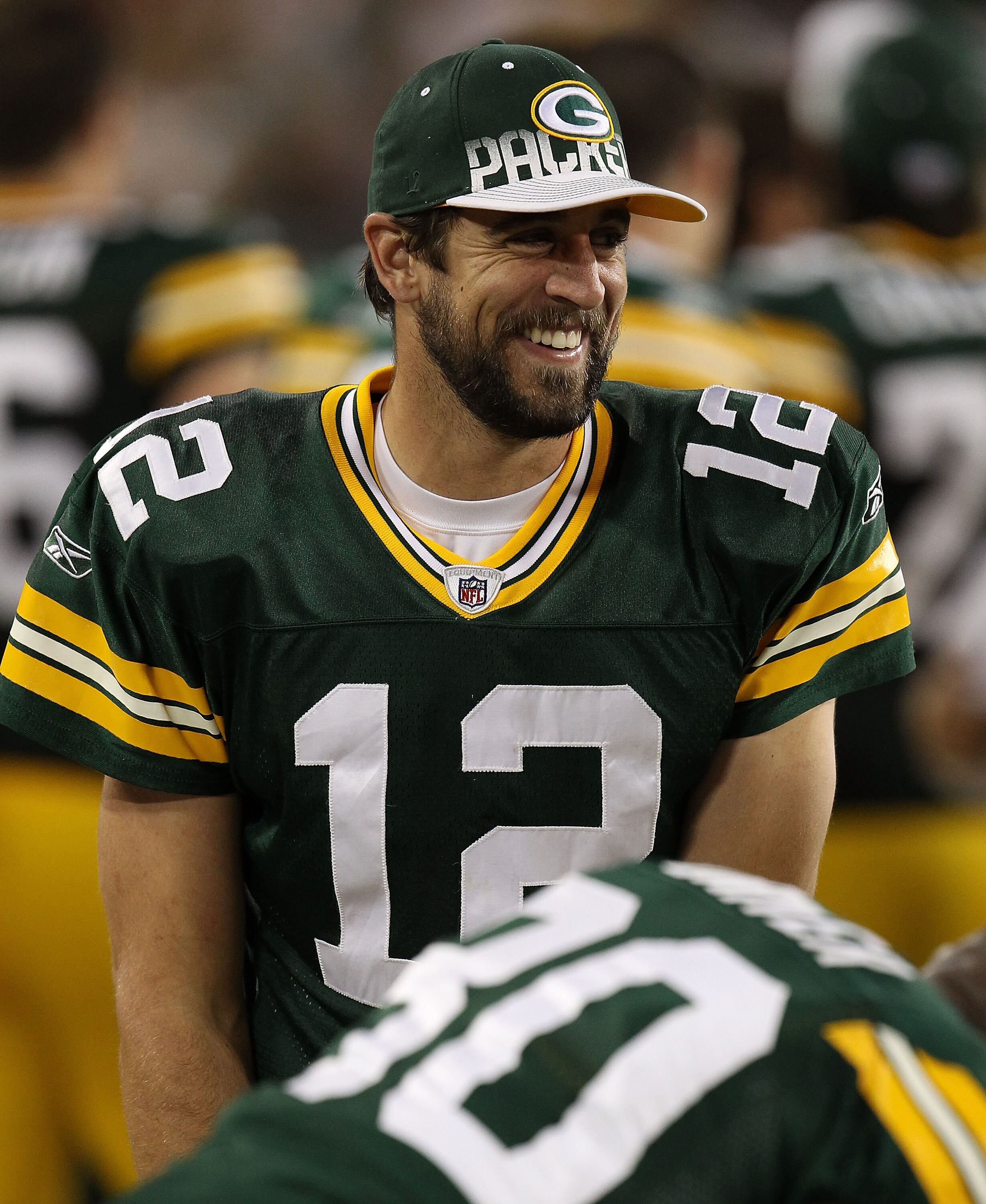 GREEN BAY, WI - AUGUST 26: Aaron Rodgers #12 of the Green Bay Packers jokes with teammate Donald Driver #80 on the sidelines during a game against the Indianapolis Colts at Lambeau Field on August 26, 2010 in Green Bay, Wisconsin. The Packer defeated the 
