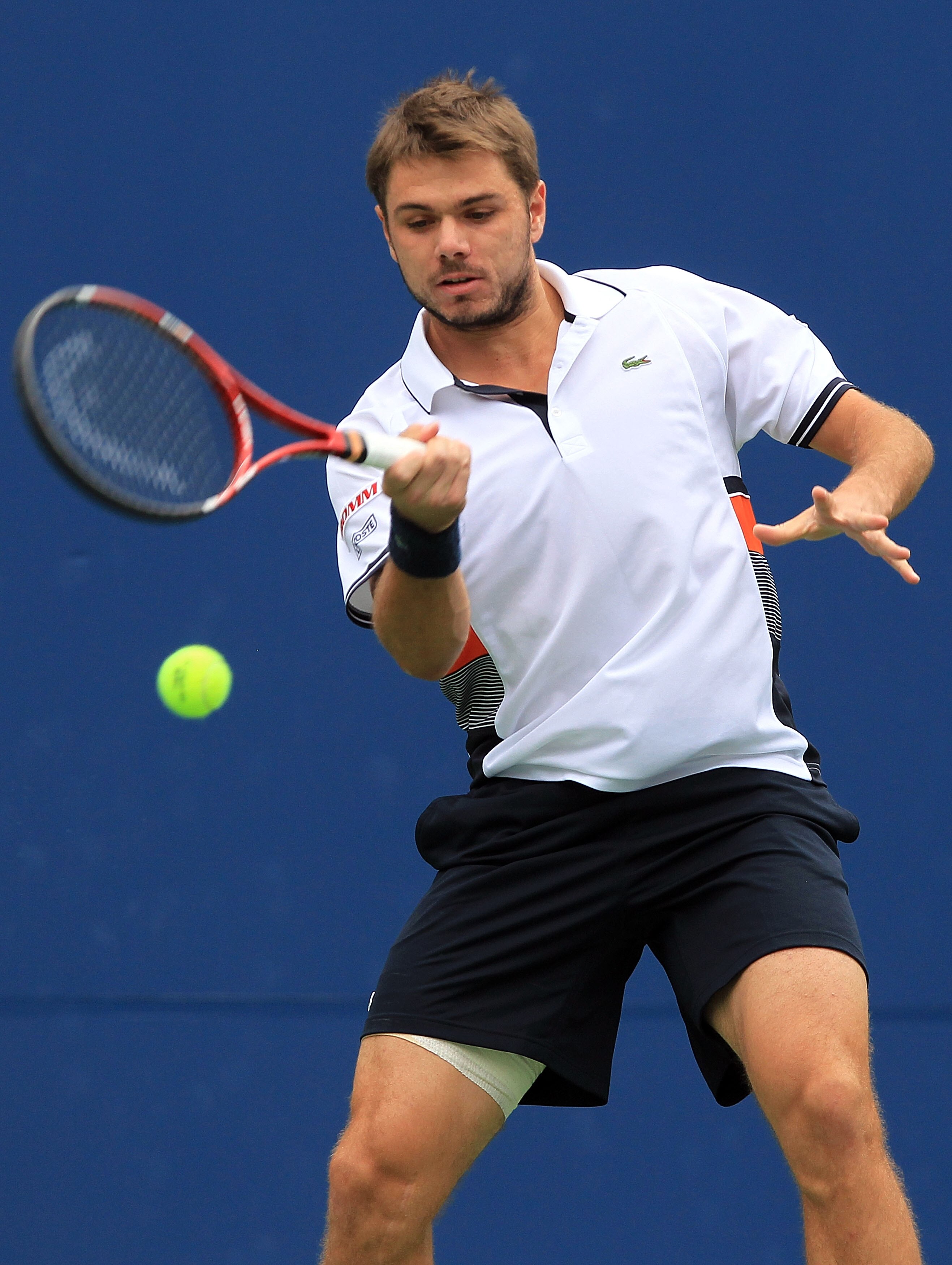 NEW YORK - SEPTEMBER 09:  Stanislas Wawrinka of Switzerland returns a shot against Mikhail Youzhny of Russia during his men's single quarterfinal match on day eleven of the 2010 U.S. Open at the USTA Billie Jean King National Tennis Center on September 9,