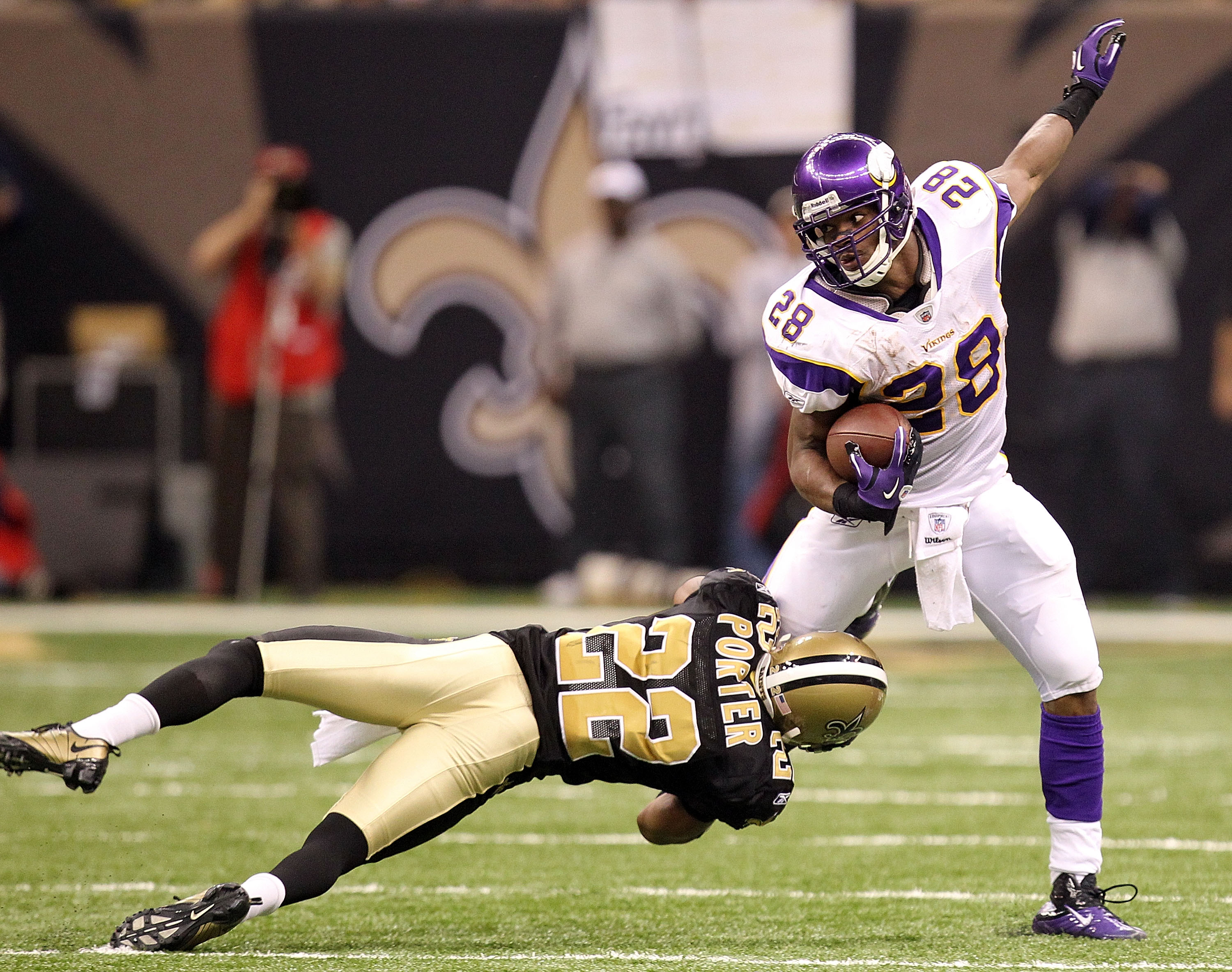 NEW ORLEANS - JANUARY 24:  Tracy Porter #22 of the New Orleans Saints attempts to tackle Adrian Peterson #28 of the Minnesota Vikings during the NFC Championship Game at the Louisana Superdome on January 24, 2010 in New Orleans, Louisiana.  (Photo by Rona
