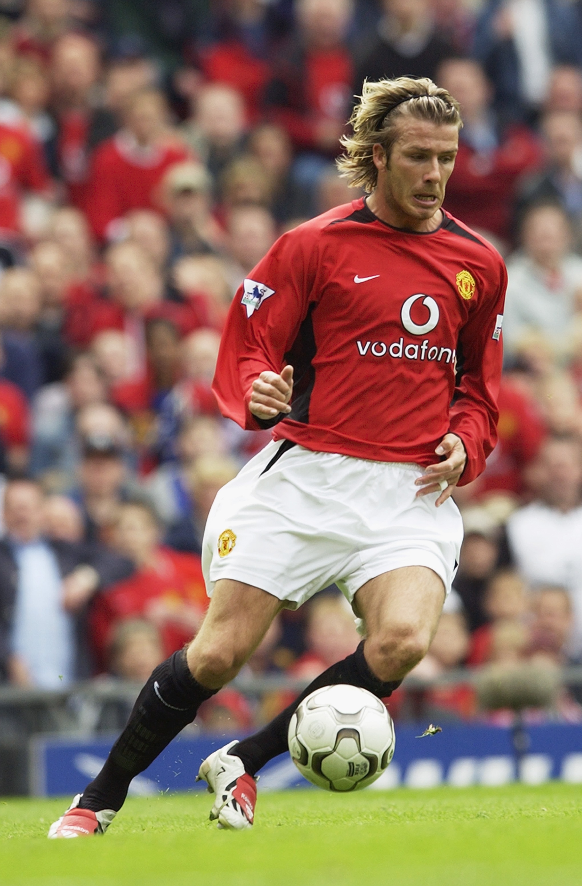 MANCHESTER - MAY 3:  David Beckham of Manchester United runs with the ball during the FA Barclaycard Premiership match between Manchester United and Charlton Athletic held on May 3, 2003 at Old Trafford, in Manchester, England. Manchester United won the m