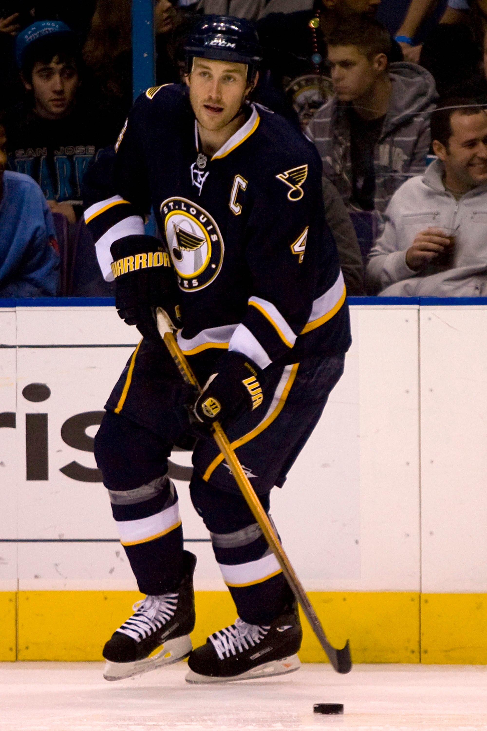 ST. LOUIS - NOVEMBER 14: Eric Brewer #4 of the St. Louis Blues moves the puck up ice against the San Jose Sharks at the Scottrade Center on November 14, 2009 in St. Louis, Missouri.  (Photo by Dilip Vishwanat/Getty Images)