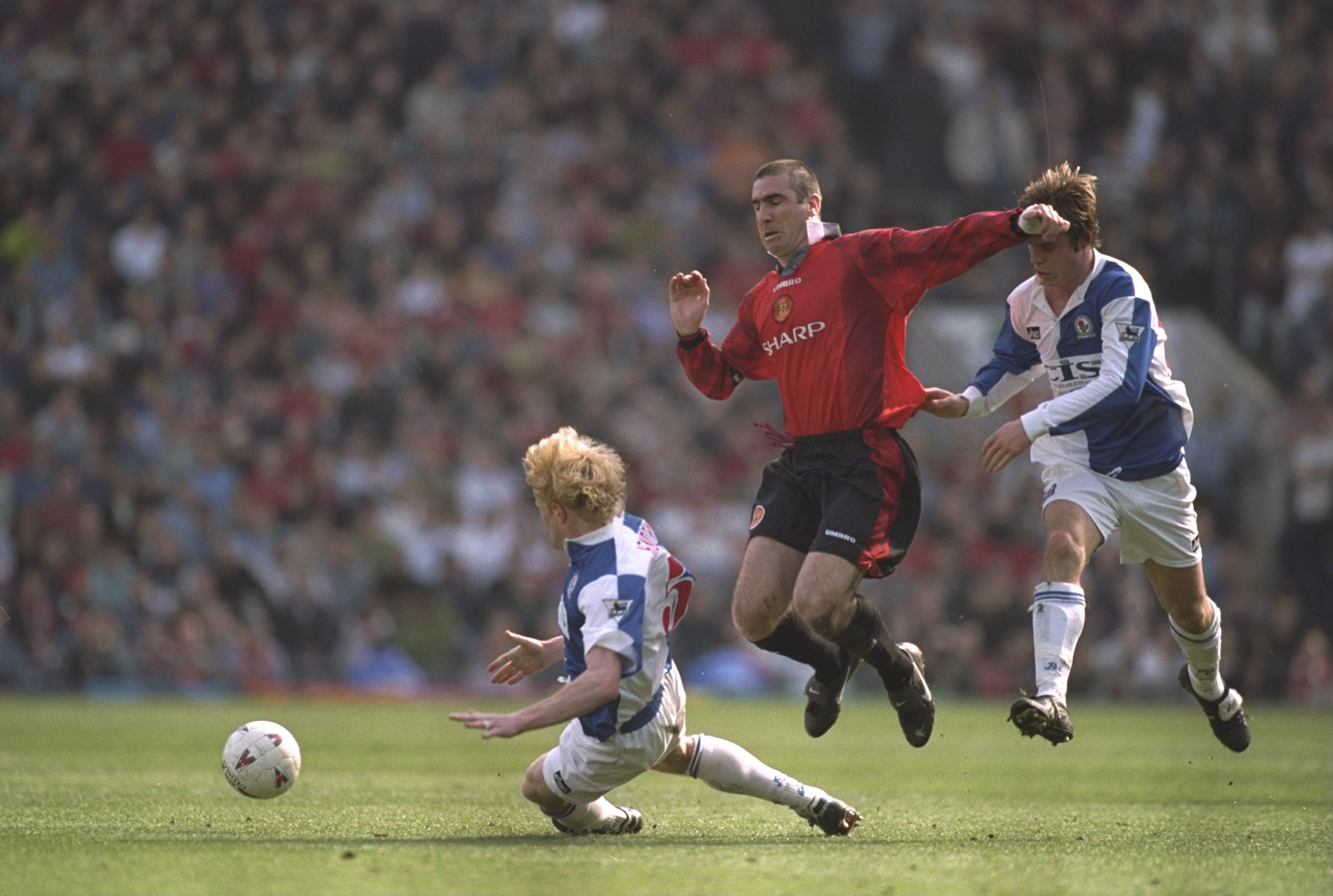 13 Apr 1997:  Eric Cantona (centre) of Manchester United leaps above  Colin Hendry (left) of Blackburn Rovers during the FA Premier League match at Ewood Park in Blackburn, England. Manchester United won 3-2. \ Mandatory Credit: Clive Brunskill /Allsport
