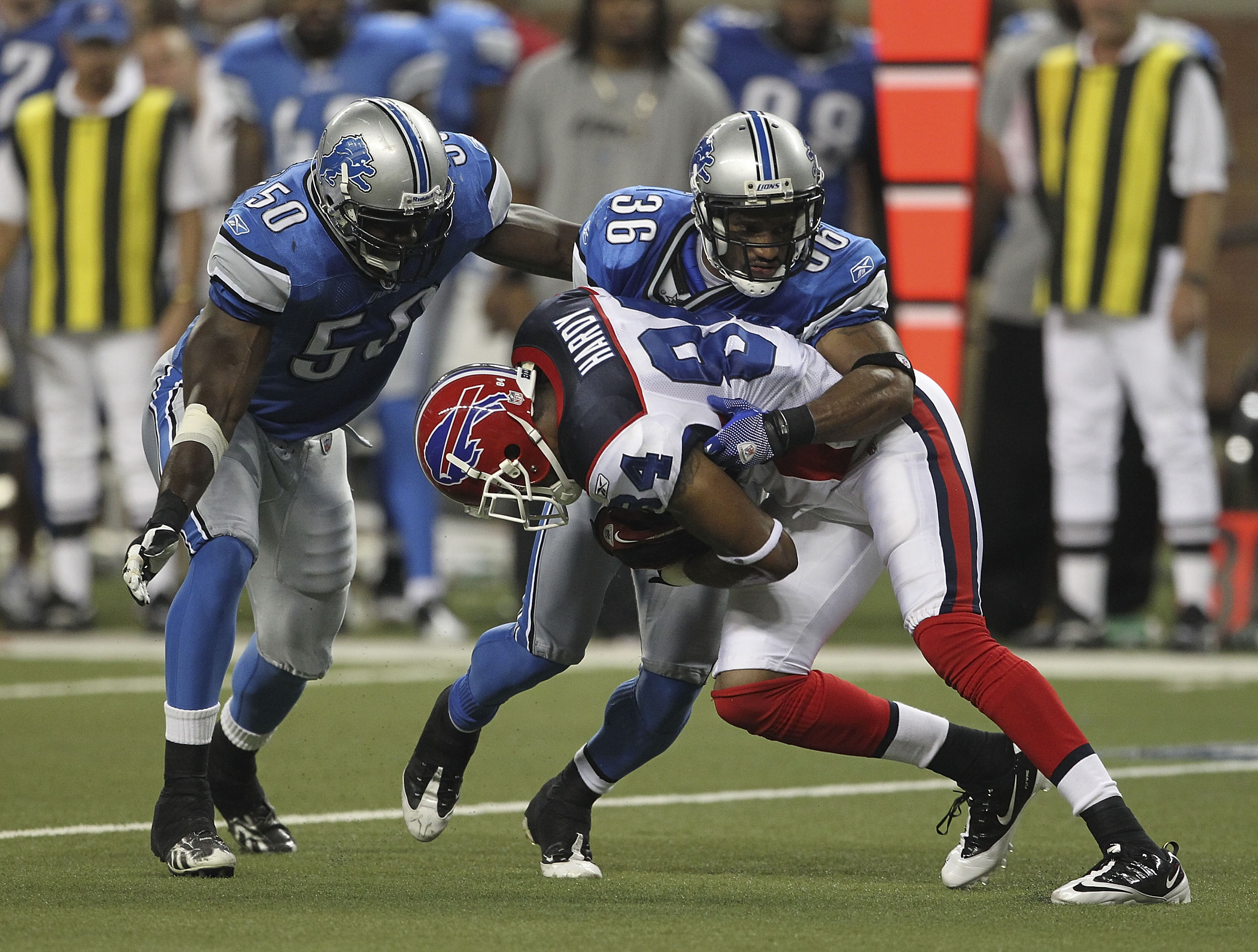 DETROIT - SEPTEMBER 02: Isaiah Ekejiuba #50 and Paul Pratt #36 of the Detroit Lions makes the stop on James Hardy #84 of the Buffalo Bills during the fouth quarter of the preseason game at Ford Field on September 2, 2010 in Detroit, Michigan. The Lions de