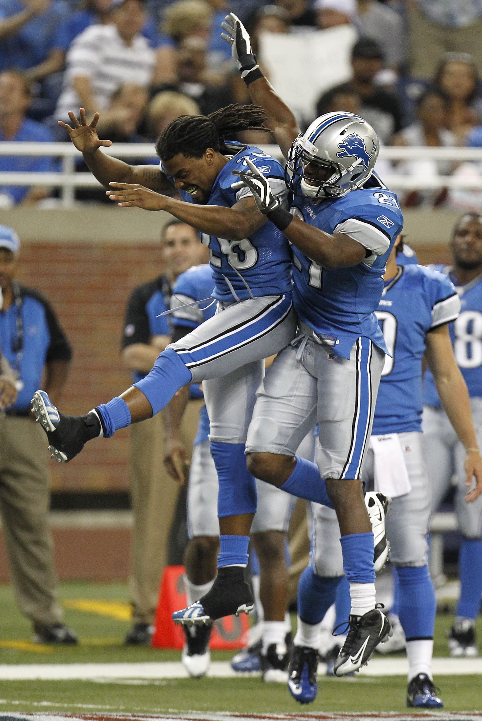DETROIT - AUGUST 28:  Aaron Brown #21  of the Detroit Lions celebrates his fourth quarter touchdown with Louis Delmas #26 while playing the Cleveland Browns in a preseason game on August 28, 2010 at Ford Field in Detroit, Michigan.  (Photo by Gregory Sham