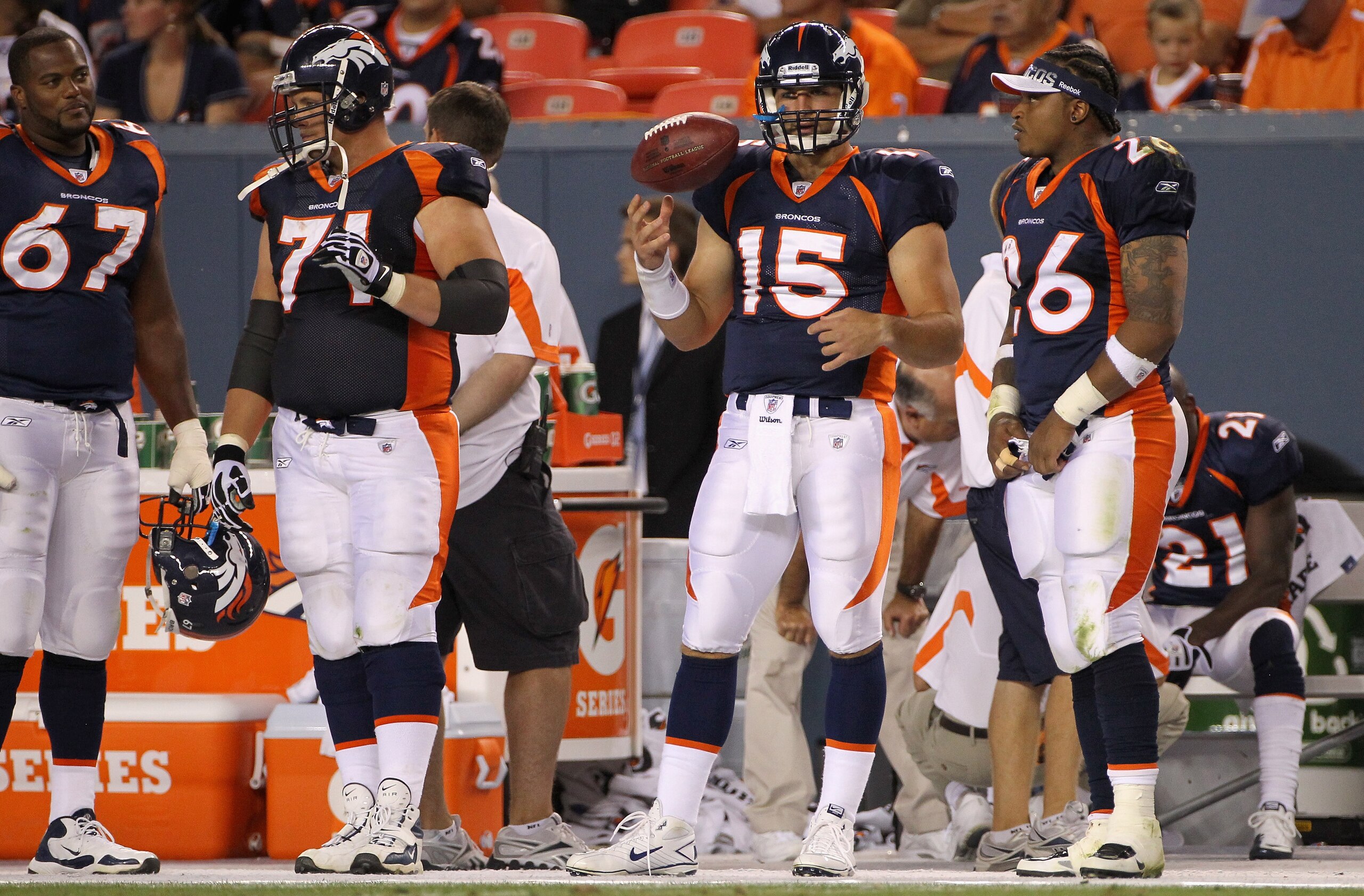 DENVER - AUGUST 29:  Quarterback Tim Tebow #15 of the Denver Broncos is prepared to enter the game as he stands on the bench with D'Anthony Batiste #67, Russ Hochstein #71 and LenDale White #26 against the Pittsburgh Steelers during preseason NFL action a