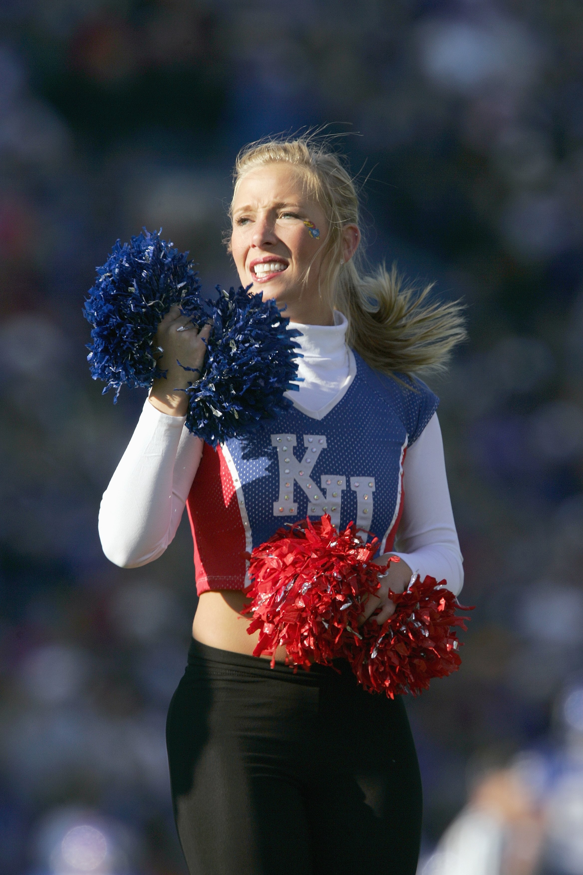 LAWRENCE, KS - NOVEMBER 18: A cheerleader of the Kansas Jayhawks stands on the field during the game against the Kansas State Wildcats at Memorial Stadium on November 18, 2006 in Lawrence, Kansas. The Kansas Jayhawks won 39-20. (Photo by Brian Bahr/Getty