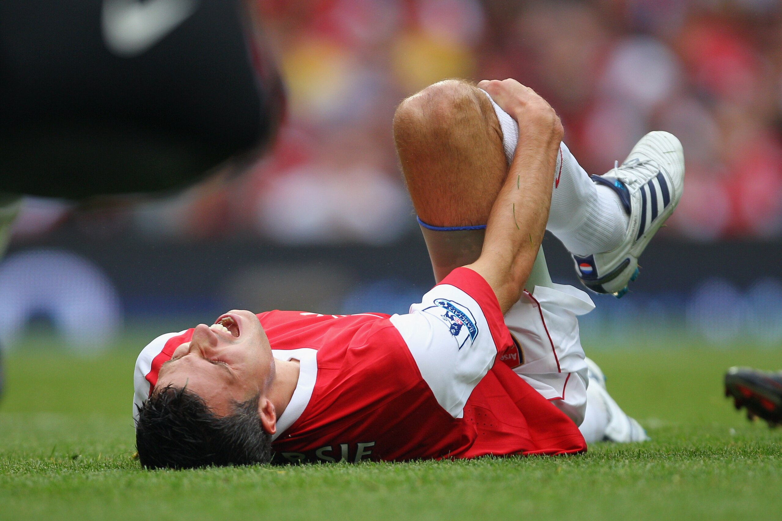 LONDON, ENGLAND - AUGUST 21:  Robin van Persie of Arsenal holds his leg after a tackle during the Barclays Premier League match between Arsenal and Blackpool at The Emirates Stadium on August 21, 2010 in London, England.  (Photo by Clive Rose/Getty Images