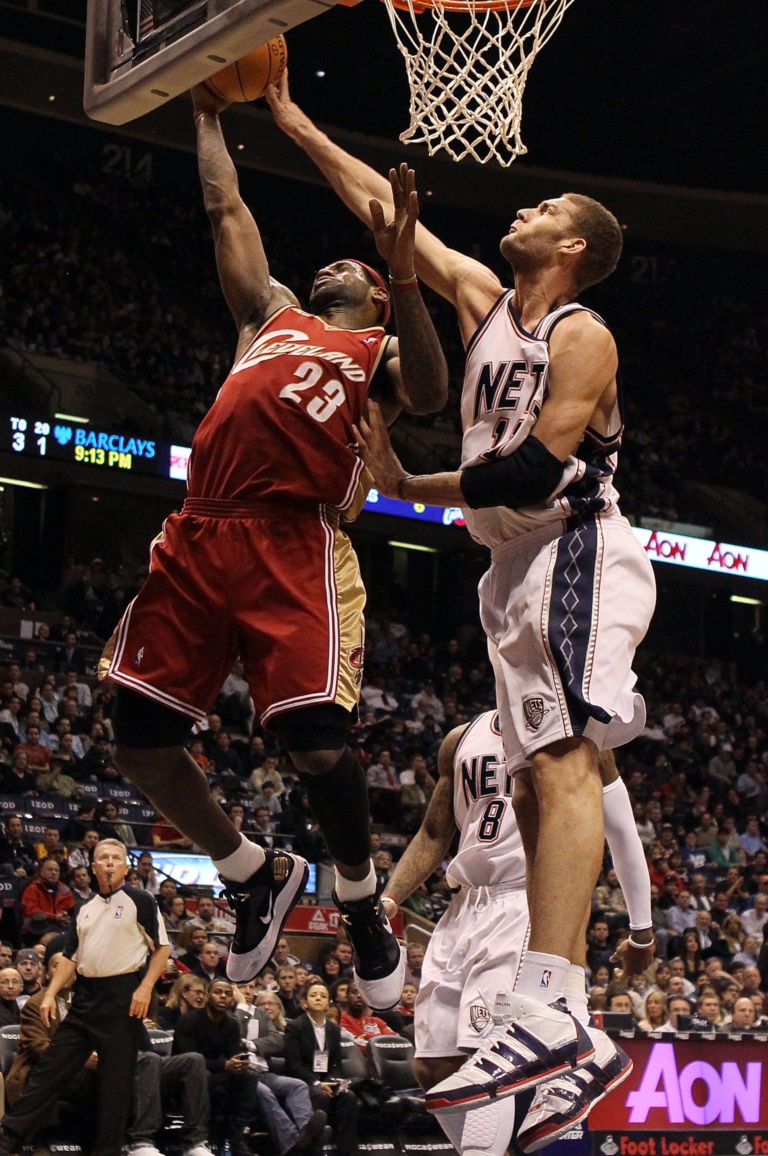 EAST RUTHERFORD, NJ - MARCH 03:  LeBron James #23 of the Cleveland Cavaliers lays up a shot against Brook Lopez #23 of the New Jersey Nets for a basket at the Izod Center on March 3, 2010 in East Rutherford, New Jersey.NOTE TO USER: User expressly acknowl