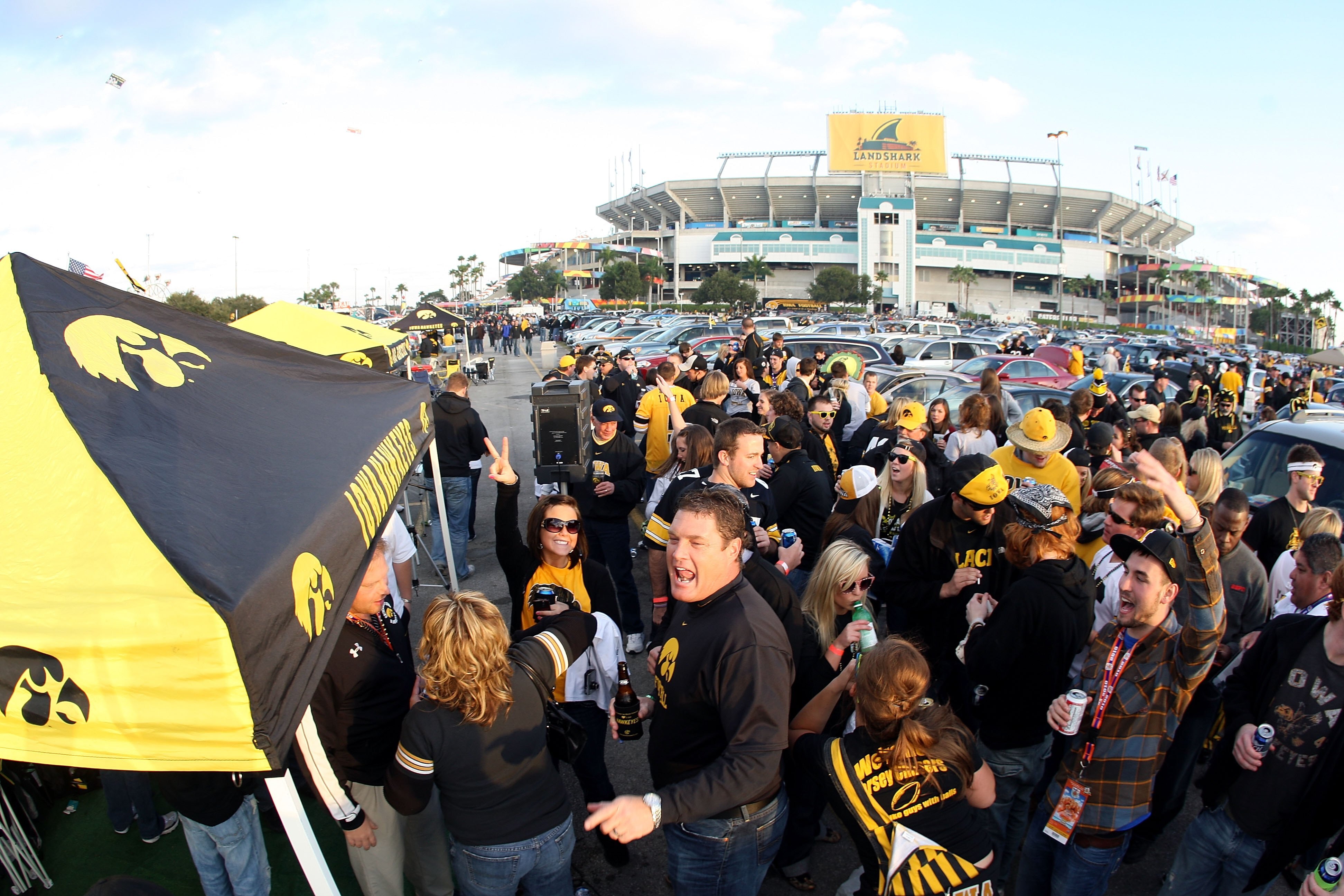 MIAMI GARDENS, FL - JANUARY 05:  Fans of the Iowa Hawkeyes tailgate outside the stadium prior to the FedEx Orange Bowl against the Georgia Tech Yellow Jackets at Land Shark Stadium on January 5, 2010 in Miami Gardens, Florida.  (Photo by Streeter Lecka/Ge