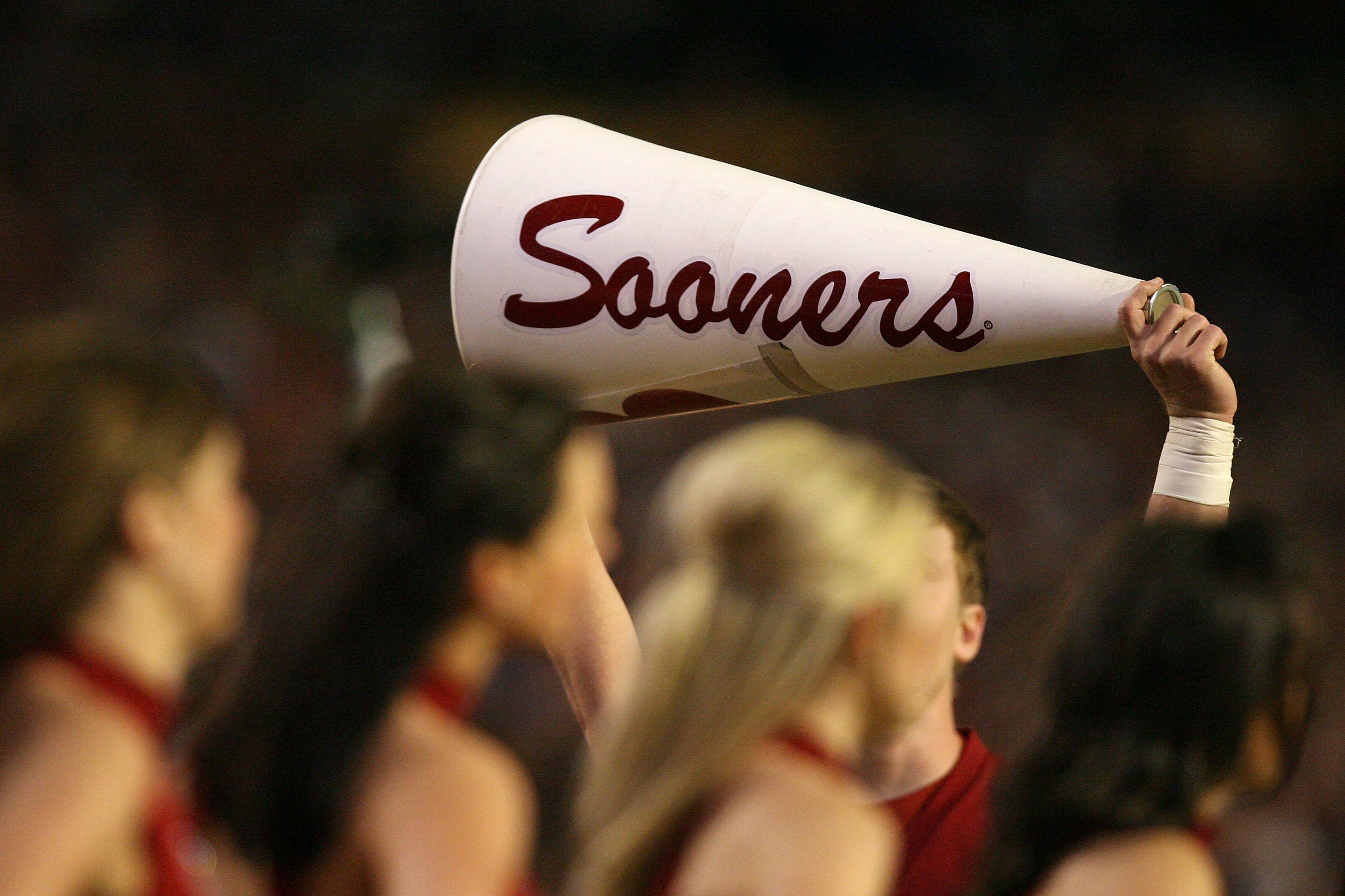 MIAMI - JANUARY 08:  Cheerleaders from the Oklahoma Sooners hold up a megaphone against the Florida Gators during the FedEx BCS National Championship game at Dolphin Stadium on January 8, 2009 in Miami, Florida.  (Photo by Doug Benc/Getty Images)