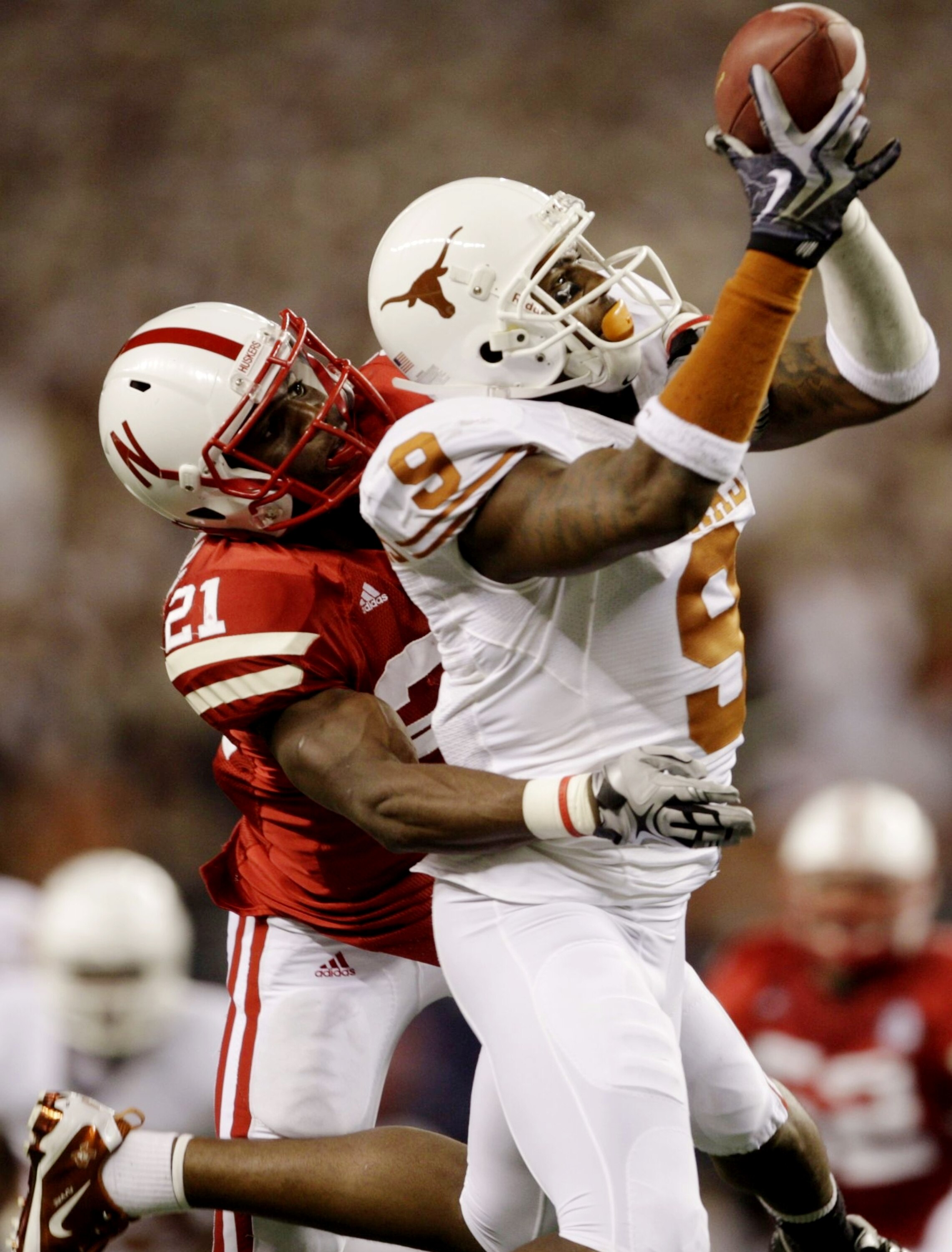 ARLINGTON, TX - DECEMBER 5:  Malcolm Williams #9 of the Texas Longhorns makes a catch in front of Prince Amukamara #21 of the Nebraska Cornhuskers in the second quarter of the game at Cowboys Stadium on December 5, 2009 in Arlington, Texas.  (Photo by Jam