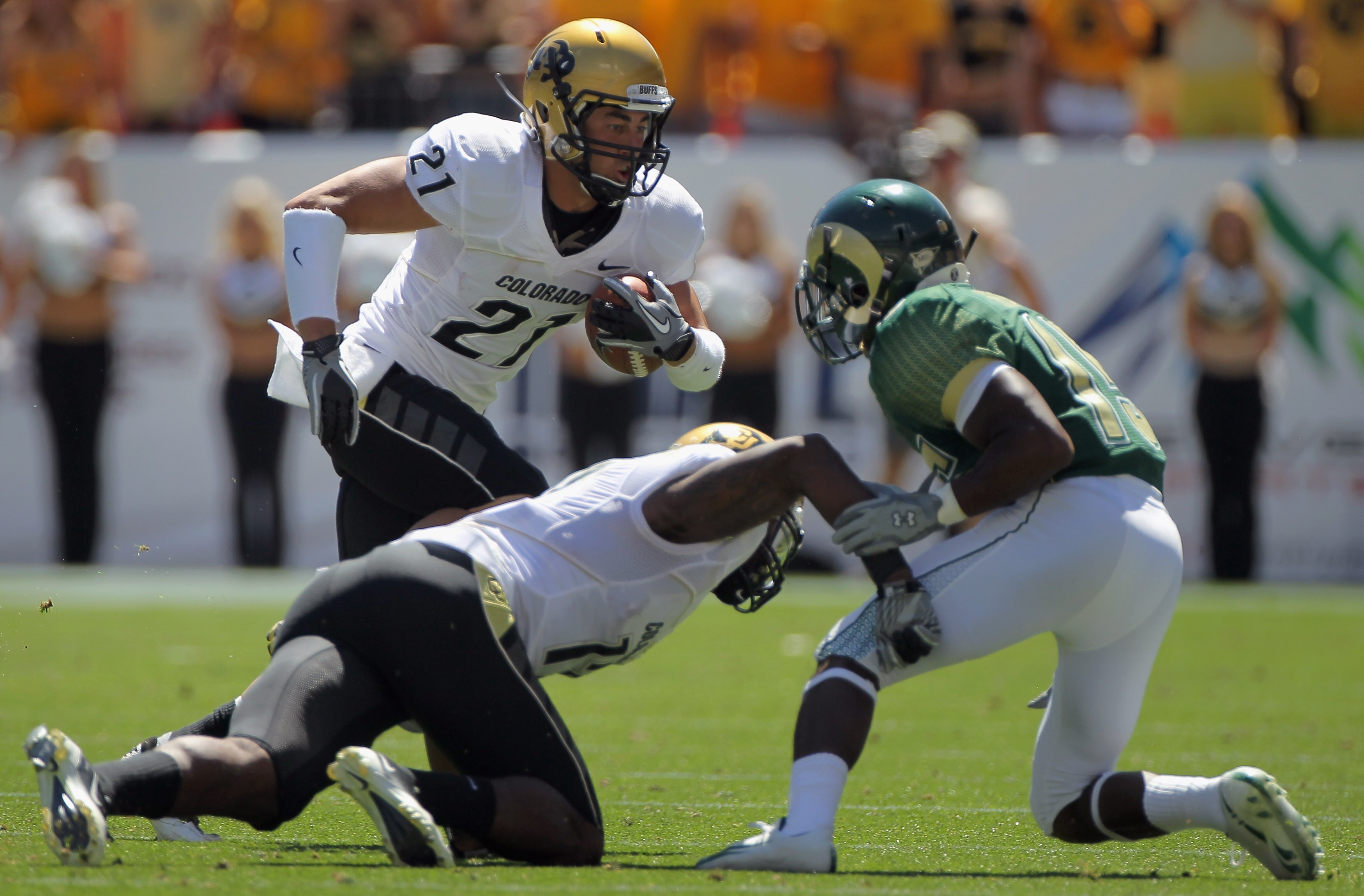 DENVER - SEPTEMBER 04:  Wide receiver Scotty McKnight #21 of the Colorado Buffaloes follows a block as he makes a reception against the Colorado State Rams in the Rocky Mountain Showdown at INVESCO Field at Mile High on September 4, 2010 in Denver, Colora