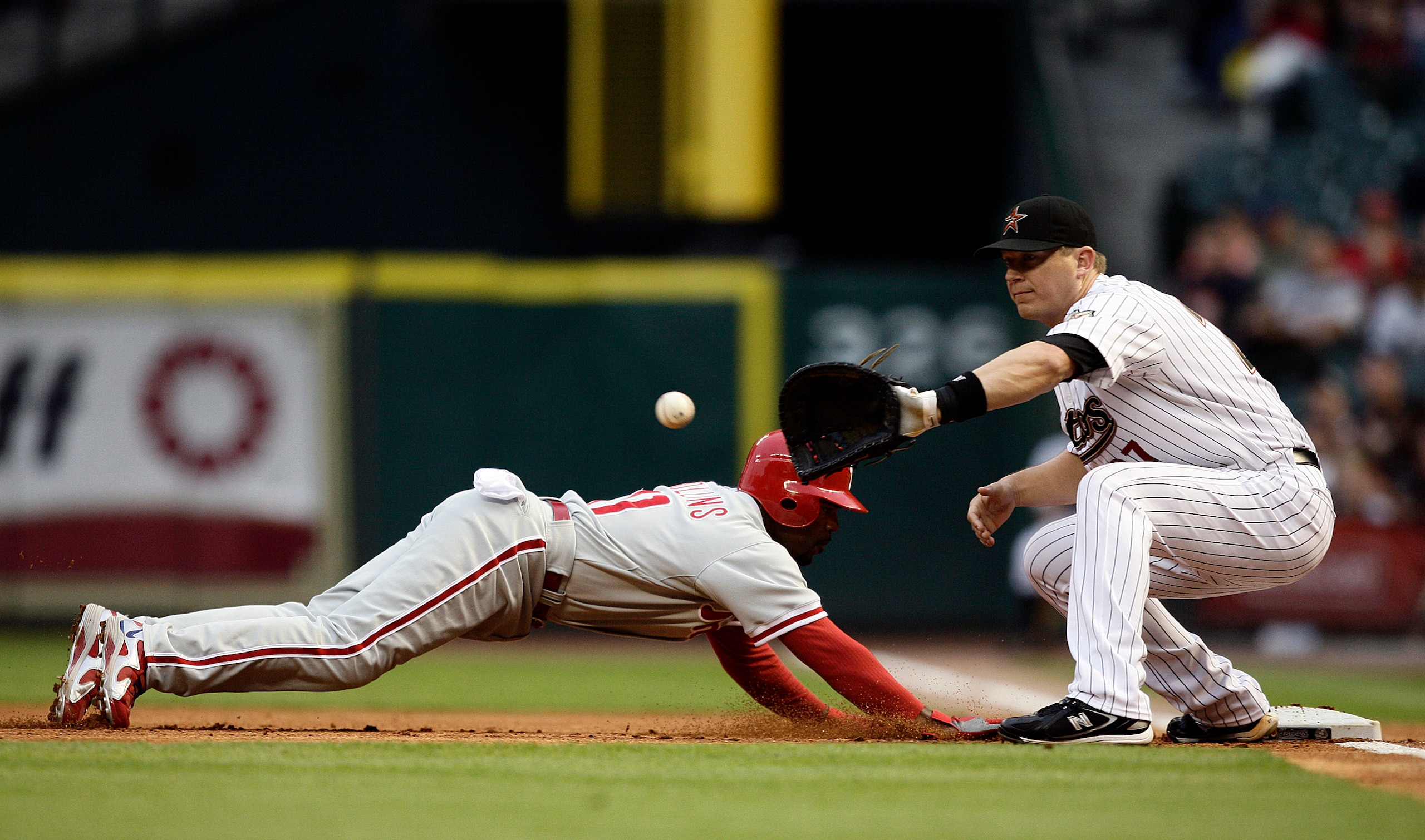 HOUSTON - APRIL 09: Jimmy Rollins #11 of the Philadelphia Phillies dives back into first base as Geoff Blum #27 awaits the throw at Minute Maid Park on April 9, 2010 in Houston, Texas. (Photo by Bob Levey/Getty Images) HOUSTON - APRIL 09: Jimmy Rollins #11 of the Philadelphia Phillies dives back into first base as Geoff Blum #27 awaits the throw at Minute Maid Park on April 9, 2010 in Houston, Texas. (Photo by Bob Levey/Getty Images)