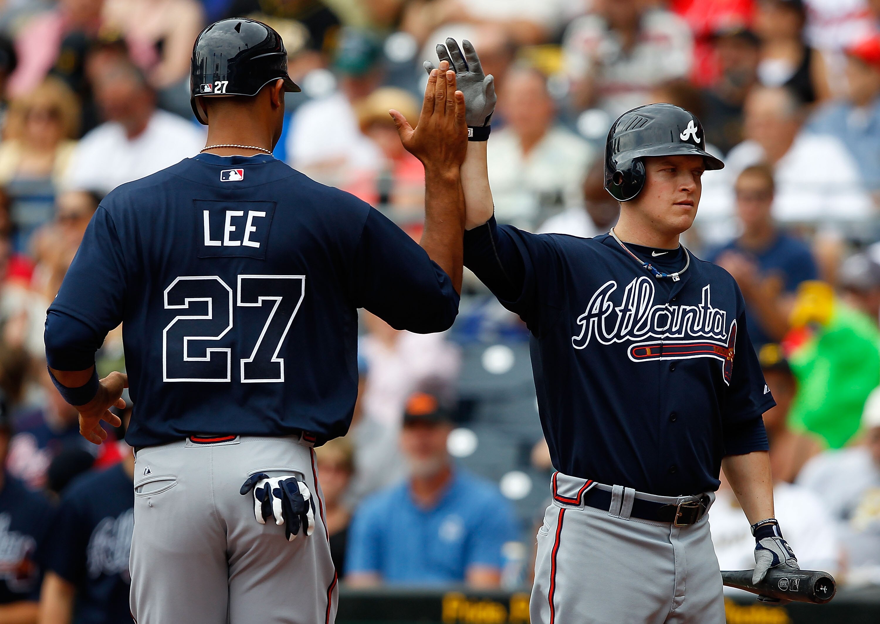 PITTSBURGH - SEPTEMBER 06:  Derrek Lee #27 of the Atlanta Braves is congratulated by teammate Nate McLouth #24 after scoring in the second inning against the Pittsburgh Pirates during the game on September 6, 2010 at PNC Park in Pittsburgh, Pennsylvania.