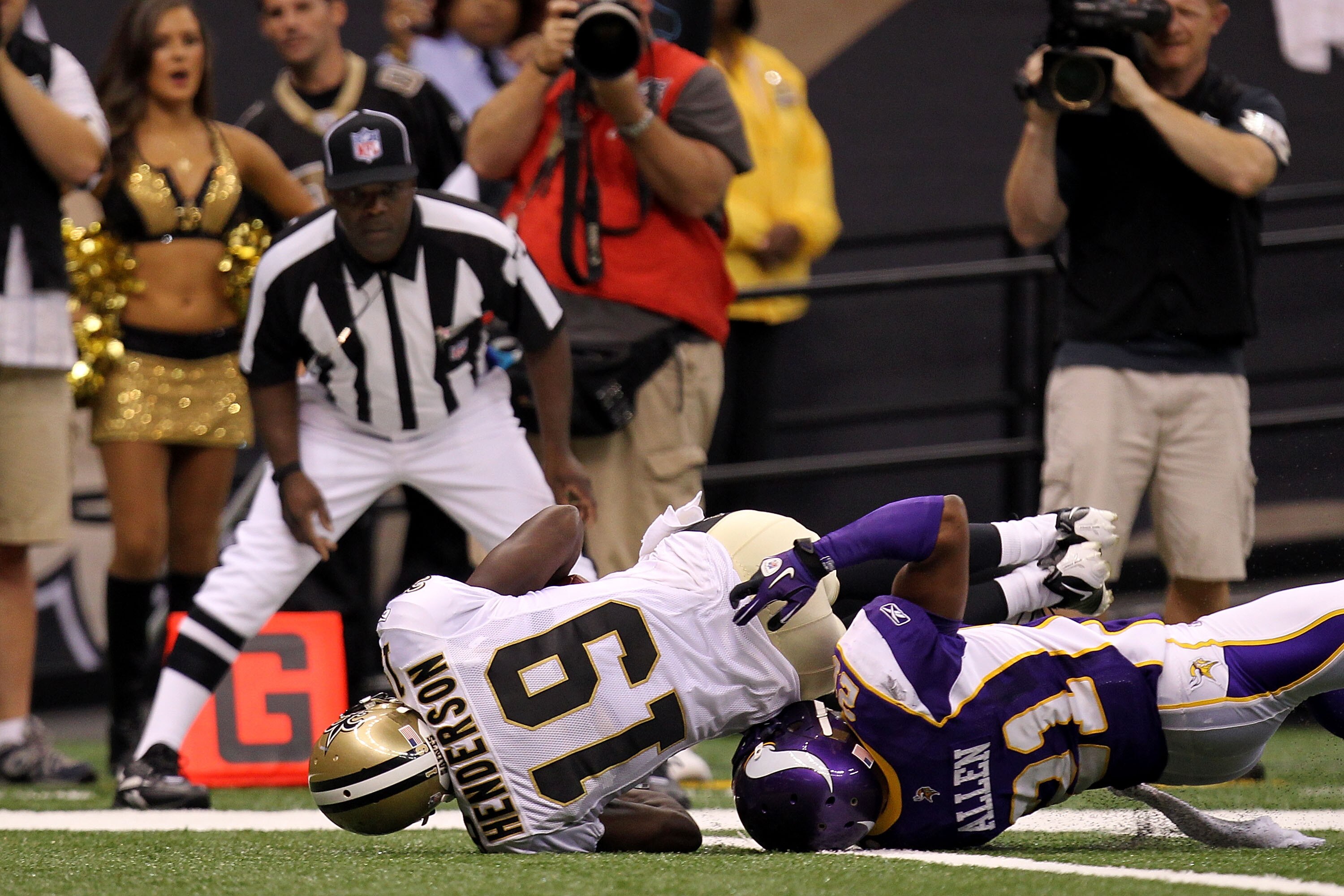 NEW ORLEANS - SEPTEMBER 09:  Devery Henderson #19 of the New Orleans Saints scors a 29-yard touchdown reception in the first quarter against Asher Allen #21 of the Minnesota Vikings at Louisiana Superdome on September 9, 2010 in New Orleans, Louisiana.  (
