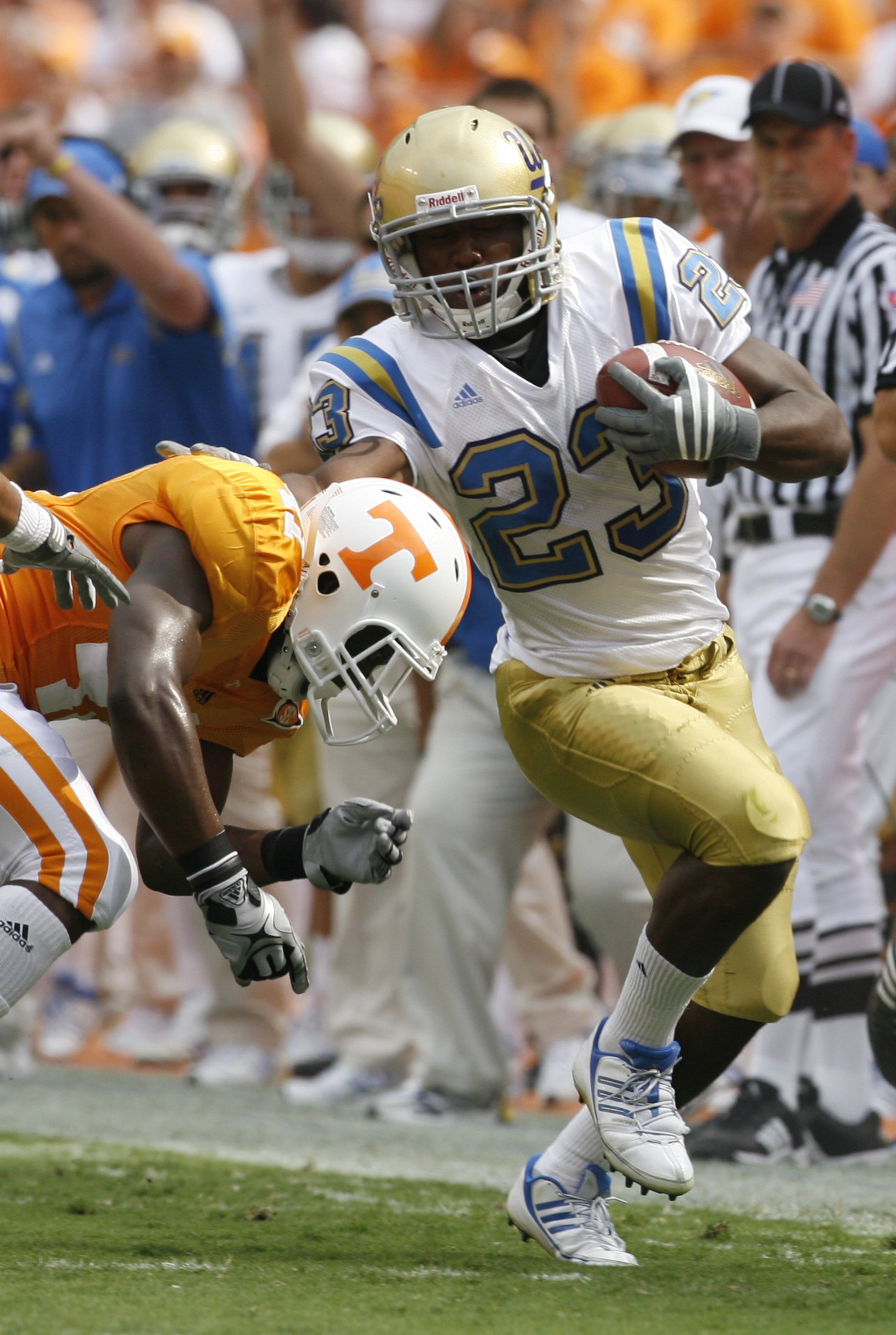 KNOXVILLE, TN - SEPTEMBER 12: Jonathan Franklin #23 of the UCLA Bruins runs against Dennis Rogan #41 of the Tennessee Volunteers on September 12, 2009 at Neyland Stadium in Knoxville, Tennessee. UCLA beat Tennessee 19-15. (Photo by Joe Murphy/Getty Images