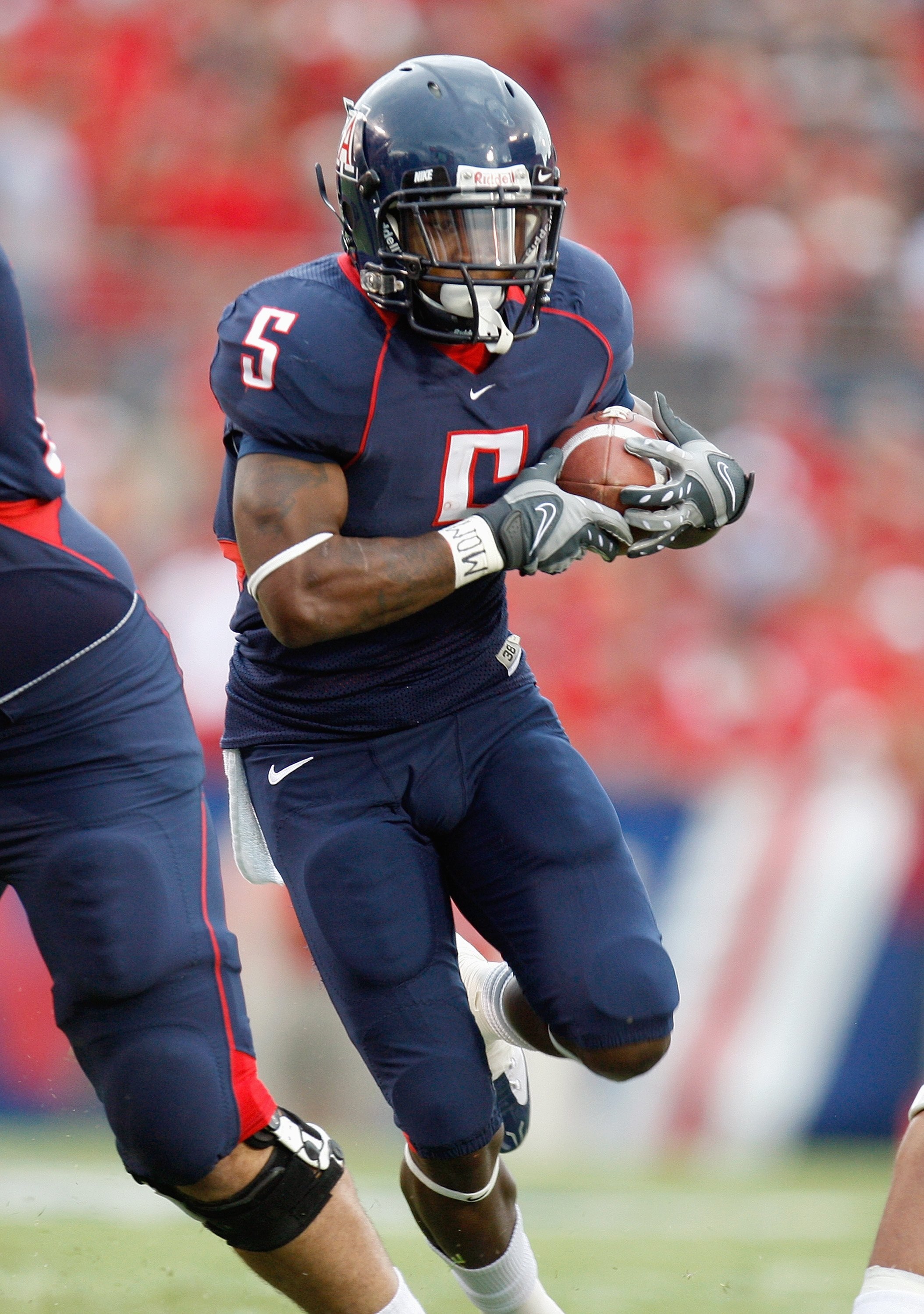 TUSCON - OCTOBER 4:  Nicolas Grigsby #5 of the Arizona Wildcats carries the ball during the game against the Washington Huskies on October 4, 2008 at Arizona Stadium in Tucson, Arizona. (Photo by: Gregory Shamus/Getty Images)