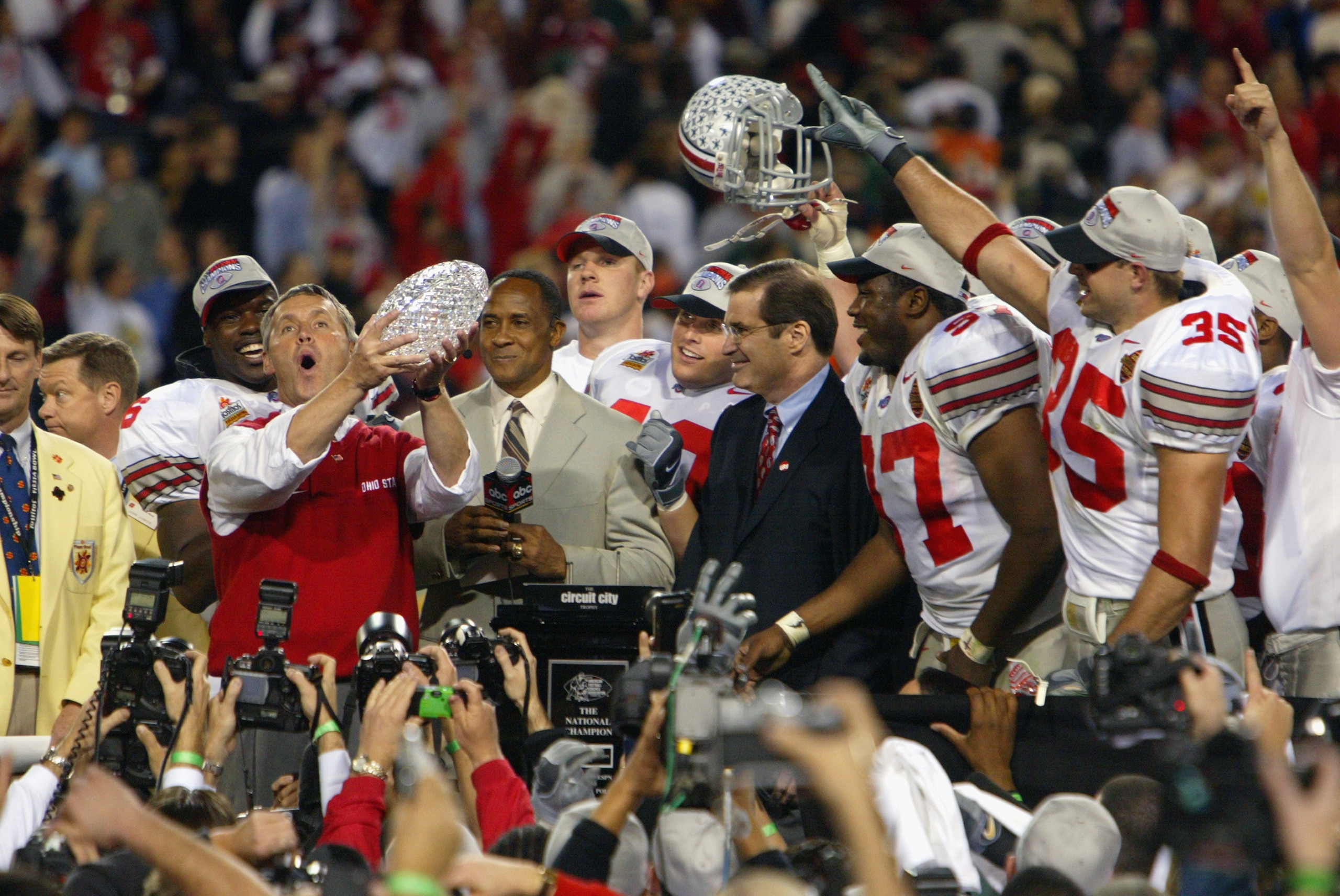 TEMPE, AZ - JANUARY 3:  Head coach Jim Tressel of the Ohio State Buckeyes holds up the National Championship trophy after his team defeated the University of Miami Hurricanes during the Tostitos Fiesta Bowl at Sun Devil Stadium on January 3, 2003 in Tempe