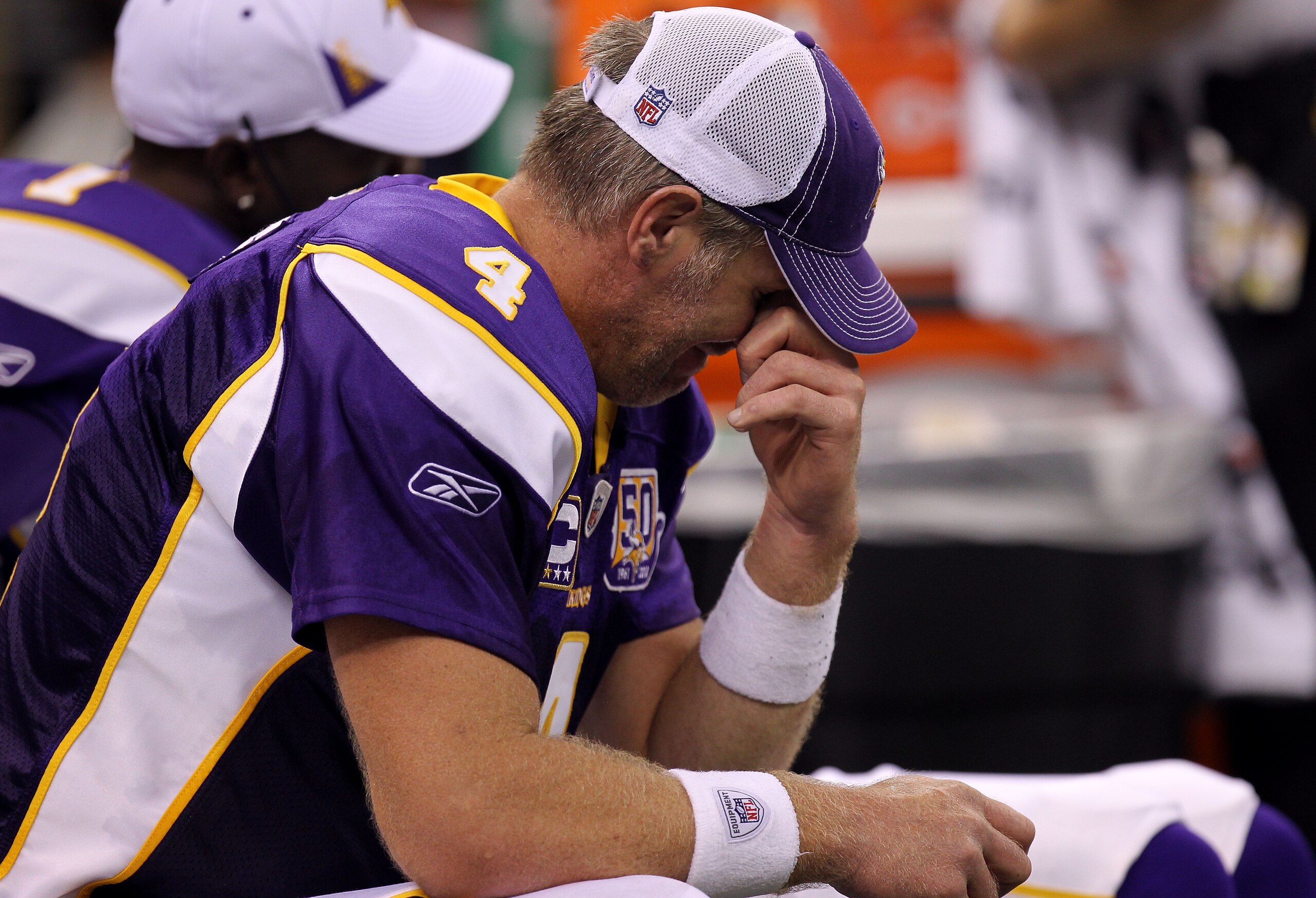 NEW ORLEANS - SEPTEMBER 09:  Quarterback Brett Favre #4 of the Minnesota Vikings sits on the bench dejected late in the fourth quarter against the New Orleans Saints at Louisiana Superdome on September 9, 2010 in New Orleans, Louisiana. The Saints won 14-