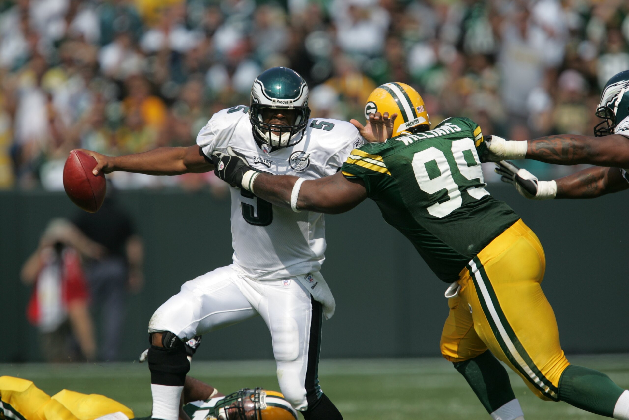 GREEN BAY, WI - SEPTEMBER 09: Donovon McNabb #5 of the Philadelphia Eagles gets away from Corey Williams #99 of the Green Bay Packers while looking for a receiver on September 9, 2007 at Lambeau Field in Green Bay, Wisconsin. The Packers defeated the Eagl