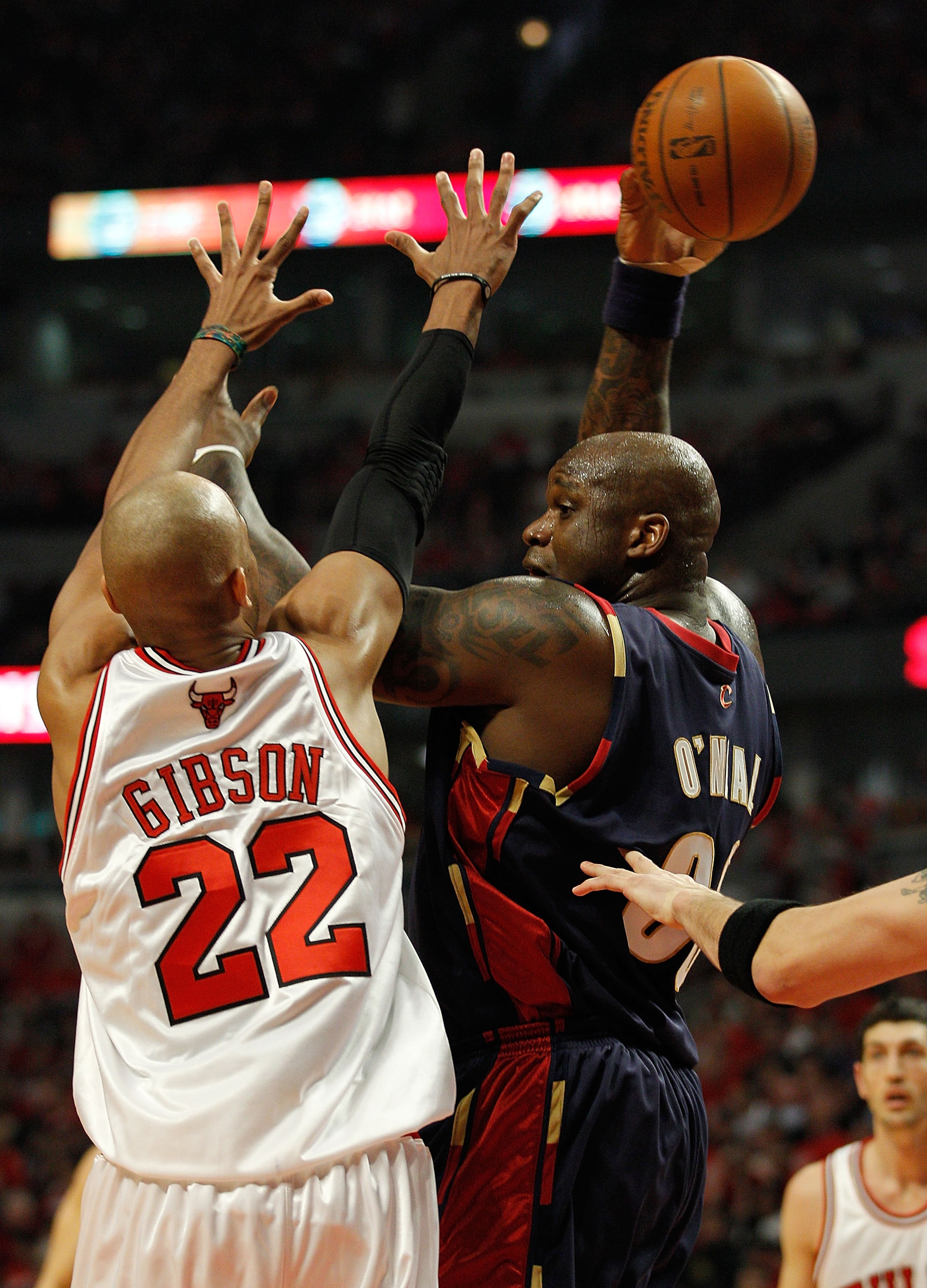 CHICAGO - APRIL 22: Shaquille O'Neal #33 of the Cleveland Cavaliers passes the ball behind his head under pressure from Taj Gibson #22 of the Chicago Bulls in Game Three of the Eastern Conference Quarterfinals during the 2010 NBA Playoffs at the United Ce