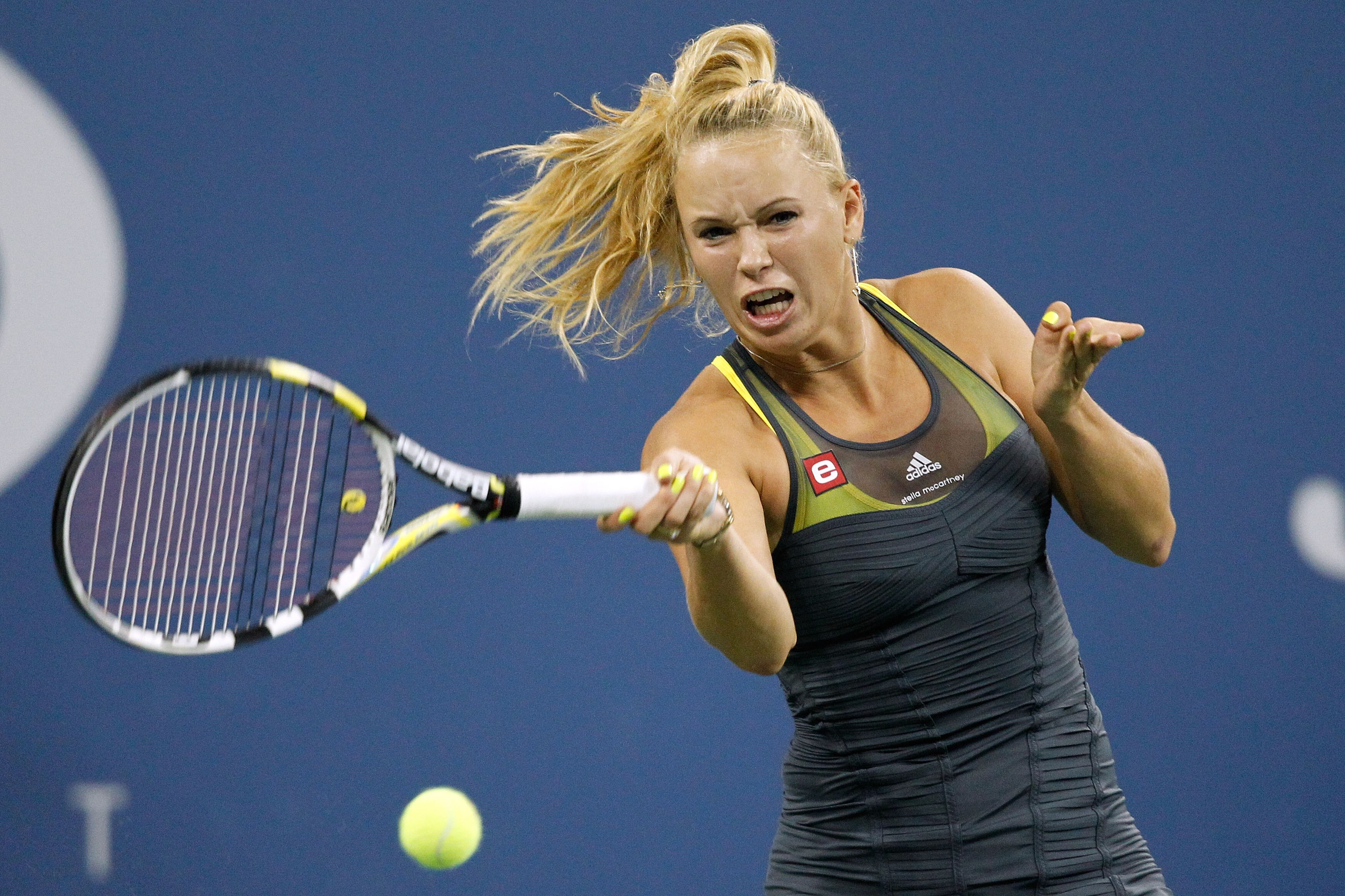NEW YORK - SEPTEMBER 08: Caroline Wozniacki of Denmark returns a shot against Dominika Cibulkova of Slovakia during her women's single quarterfinal match during day ten of the 2010 U.S. Open at the USTA Billie Jean King National Tennis Center on Septembe NEW YORK - SEPTEMBER 08: Caroline Wozniacki of Denmark returns a shot against Dominika Cibulkova of Slovakia during her women's single quarterfinal match during day ten of the 2010 U.S. Open at the USTA Billie Jean King National Tennis Center on Septembe