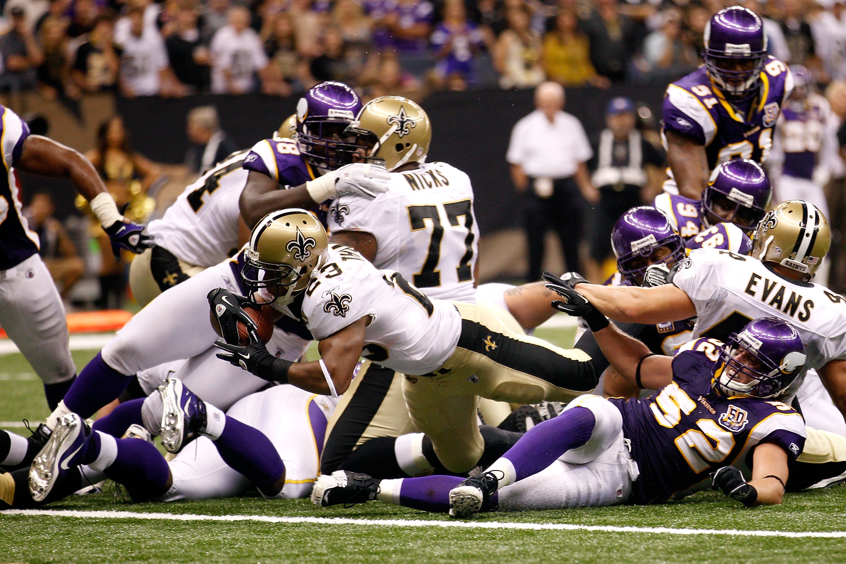 NEW ORLEANS - SEPTEMBER 09:  Pierre Thomas #23 of the New Orleans Saints scores a 1-yard rushing touchdown in the third quarter against Chad Greenway #52 of the Minnesota Vikings at Louisiana Superdome on September 9, 2010 in New Orleans, Louisiana.  (Pho