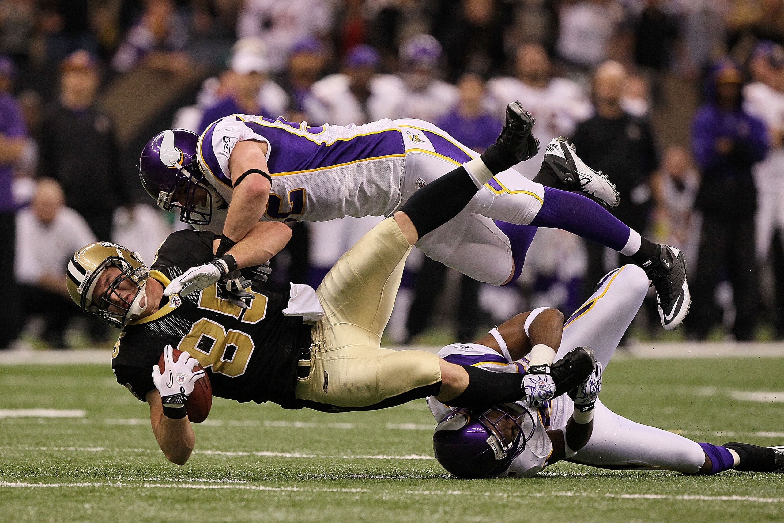 NEW ORLEANS - JANUARY 24:  Jeremy Shockey #88 of the New Orleans Saints gets tackled by Chad Greenway #52 and Antoine Winfield #26 of the Minnesota Vikings after catching a pass for a first down during the NFC Championship Game at the Louisana Superdome o