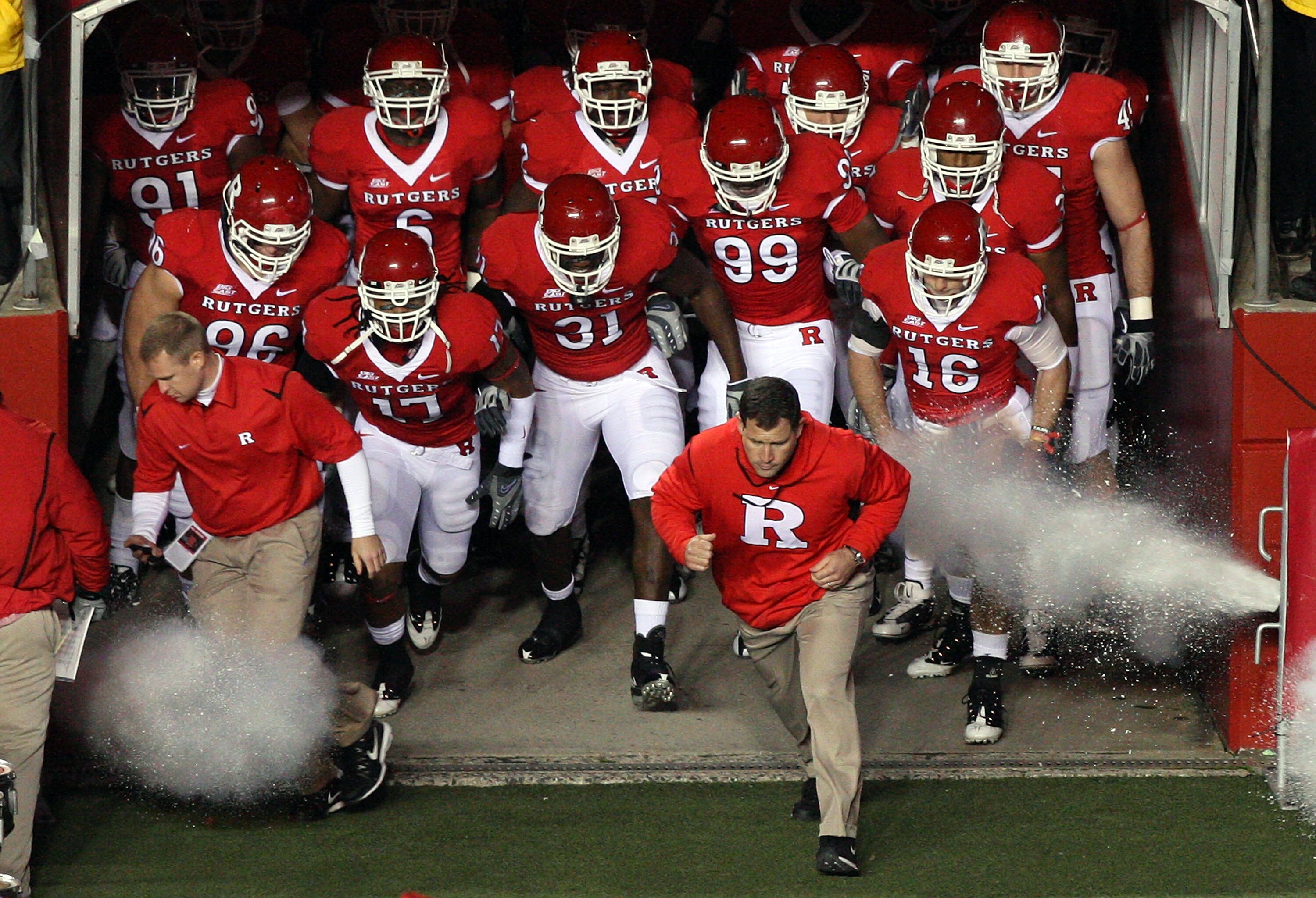 PISCATAWAY, NJ - NOVEMBER 12:  Head coach Greg Schiano of the Rutgers Scarlet Knights leads his team on the field to play against the South Florida Bulls at Rutgers Stadium on November 12, 2009 in Piscataway, New Jersey.  (Photo by Jim McIsaac/Getty Image