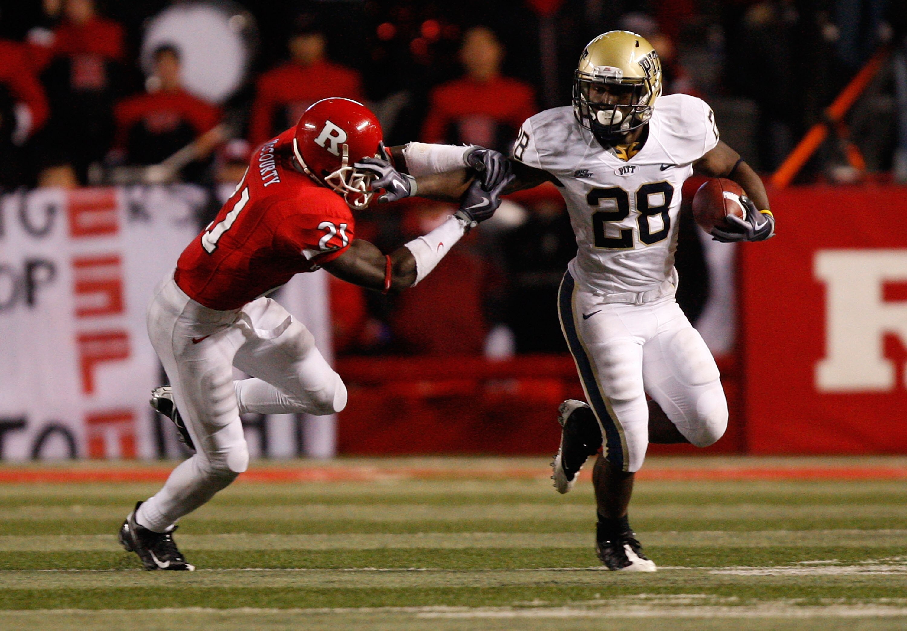 PISCATAWAY, NJ - OCTOBER 16:  Dion Lewis #28 of the University of Pittsburgh Panthers stiff arms Devin Mccourty #21 of the Rutgers University Scarlett Knights on October 16, 2009 at Rutgers Stadium in Piscataway, New Jersey.  (Photo by Jared Wickerham/Get