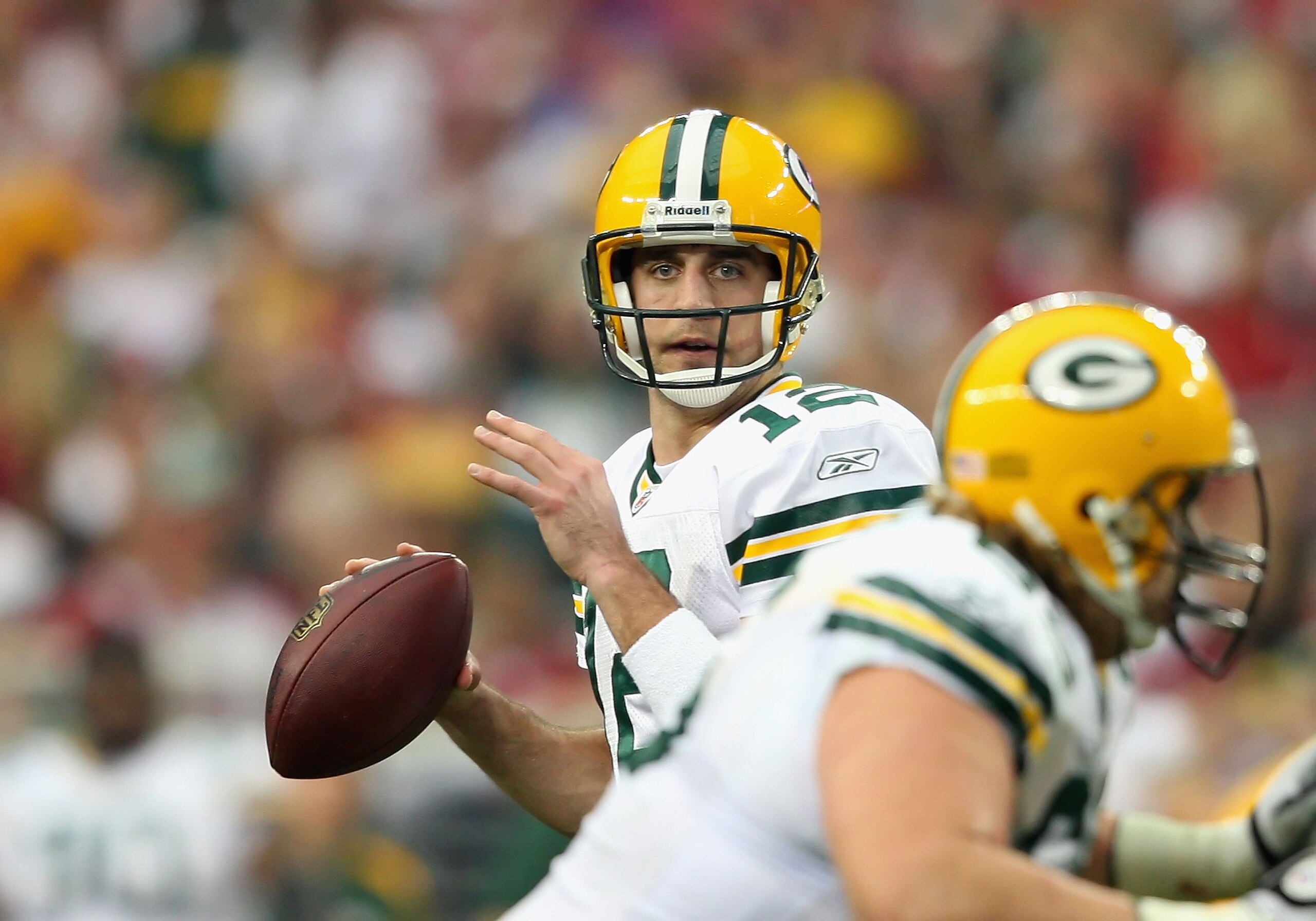 GLENDALE, AZ - JANUARY 03: Quarterback Aaron Rodgers #12 of the Green Bay Packers drops back to pass during the NFL game against the Arizona Cardinals at the Universtity of Phoenix Stadium on January 3, 2010 in Glendale, Arizona. The Packers defeated th GLENDALE, AZ - JANUARY 03: Quarterback Aaron Rodgers #12 of the Green Bay Packers drops back to pass during the NFL game against the Arizona Cardinals at the Universtity of Phoenix Stadium on January 3, 2010 in Glendale, Arizona. The Packers defeated th