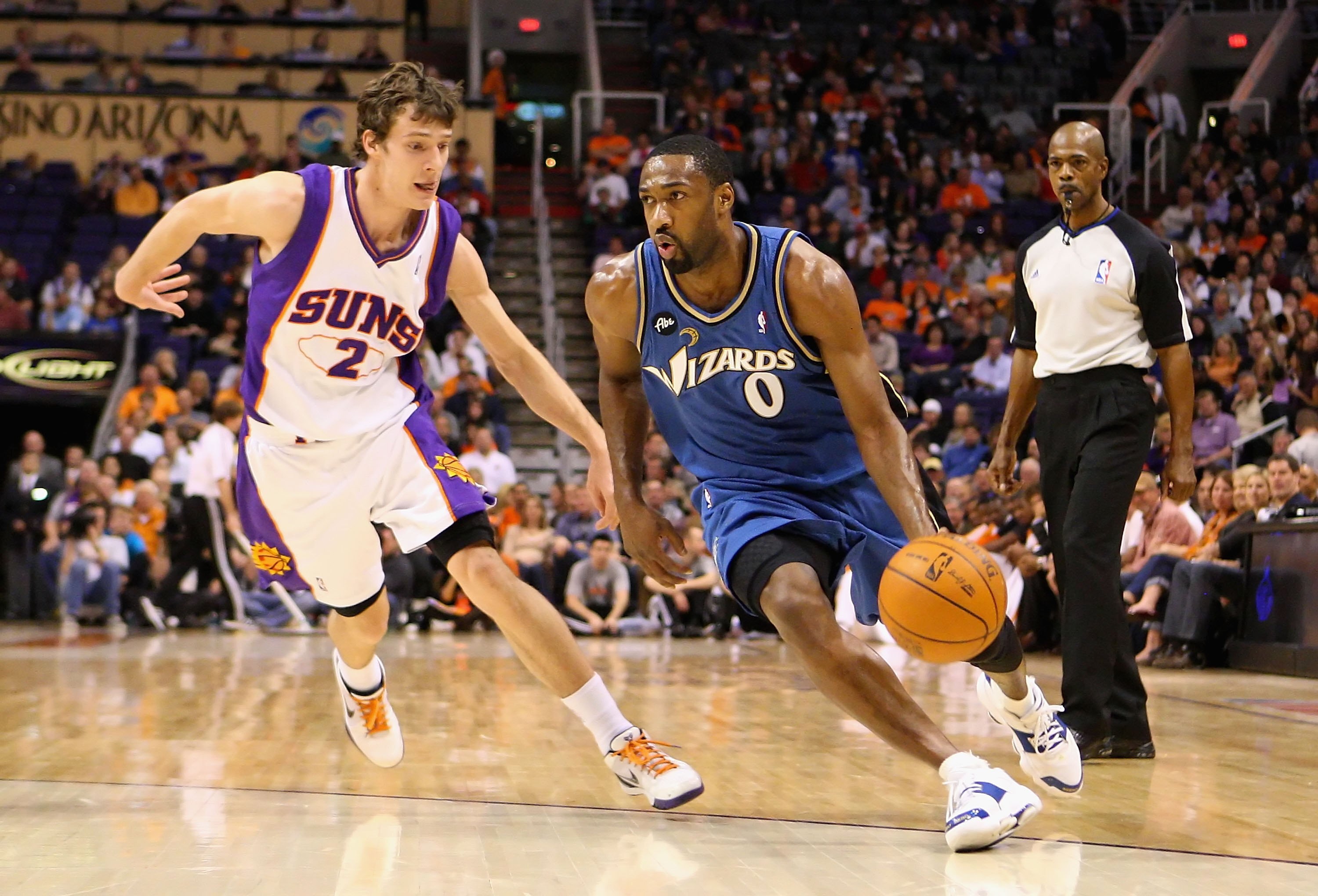 PHOENIX - DECEMBER 19:  Gilbert Arenas #0 of the Washington Wizards drives the ball past Goran Dragic #2 of the Phoenix Suns during the NBA game at US Airways Center on December 19, 2009 in Phoenix, Arizona. The Suns defeated the Wizards 121-95.  NOTE TO