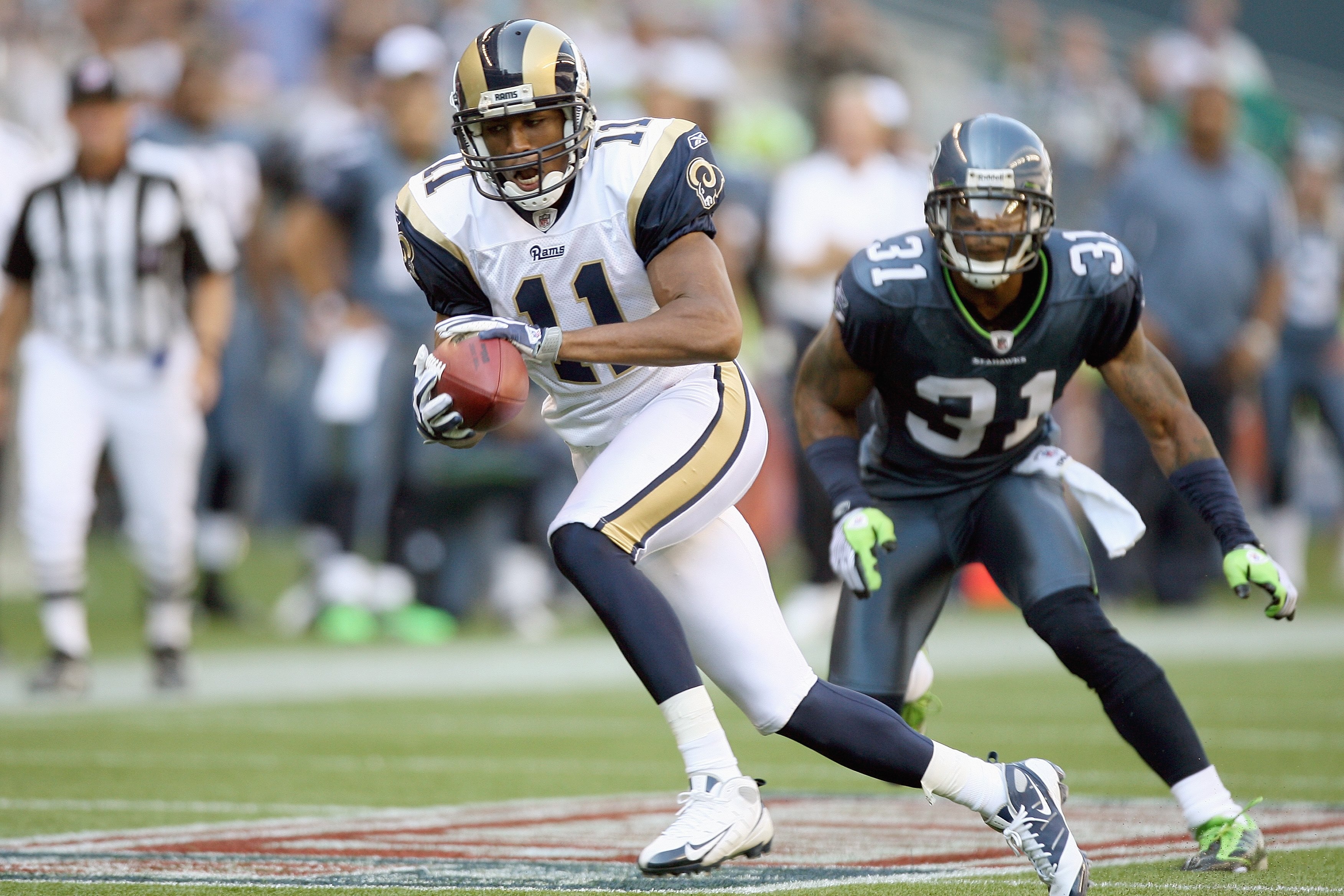SEATTLE, WA - SEPTEMBER 13:  Laurent Robinson #11 of the St. Louis Rams carries the ball during the game against the Seattle Seahawks on September 13, 2009 at Qwest Field in Seattle, Washington. The Seahawks defeated the Rams 28-0. (Photo by Otto Greule J