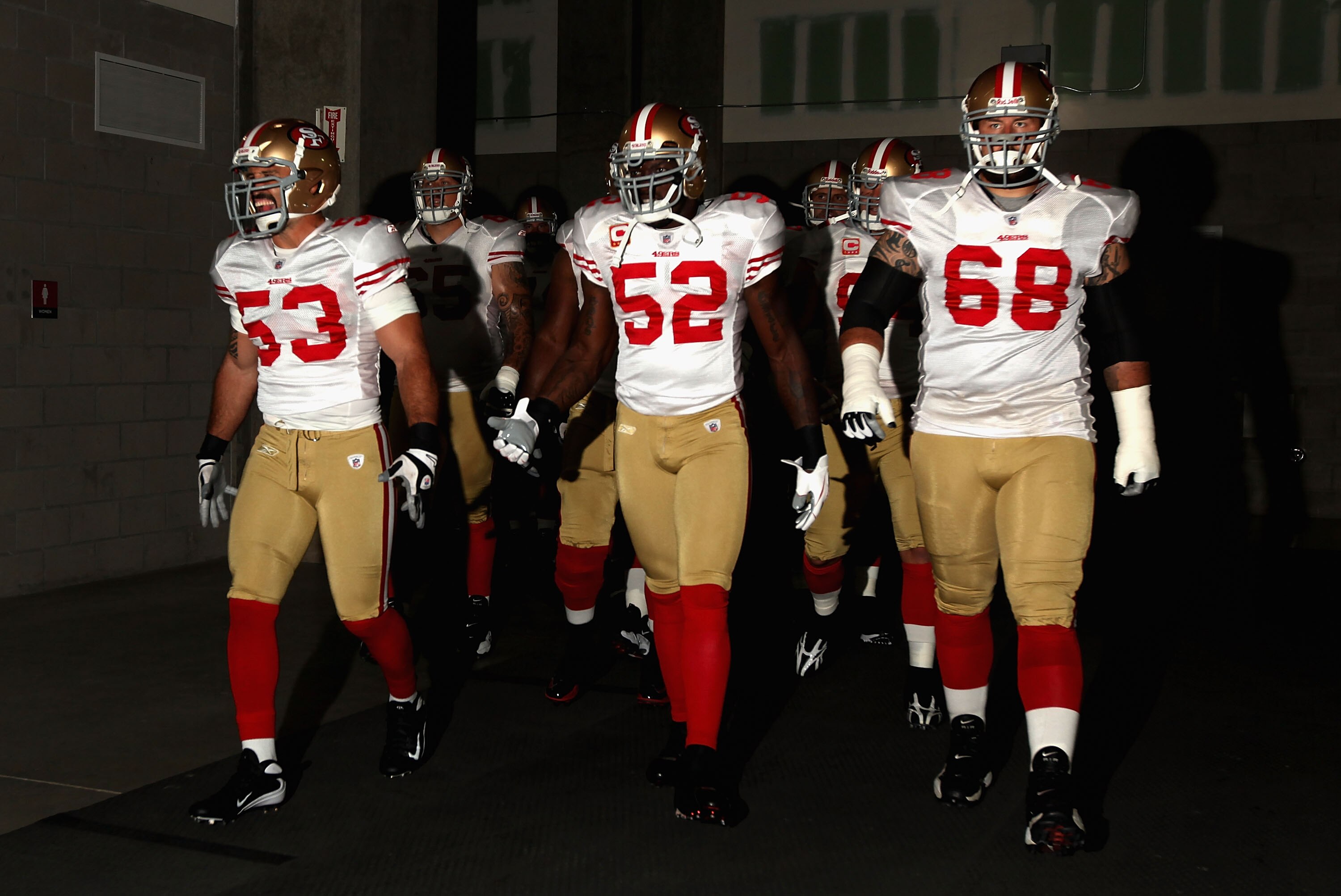 GLENDALE, AZ - SEPTEMBER 13:  (L-R) Jeff Ulbrich #53, Patrick Willis #52 and Adam Snyder #68 of the San Francisco 49ers walk out onto the field prior to the NFL game against the Arizona Cardinals at the Universtity of Phoenix Stadium on September 13, 2009