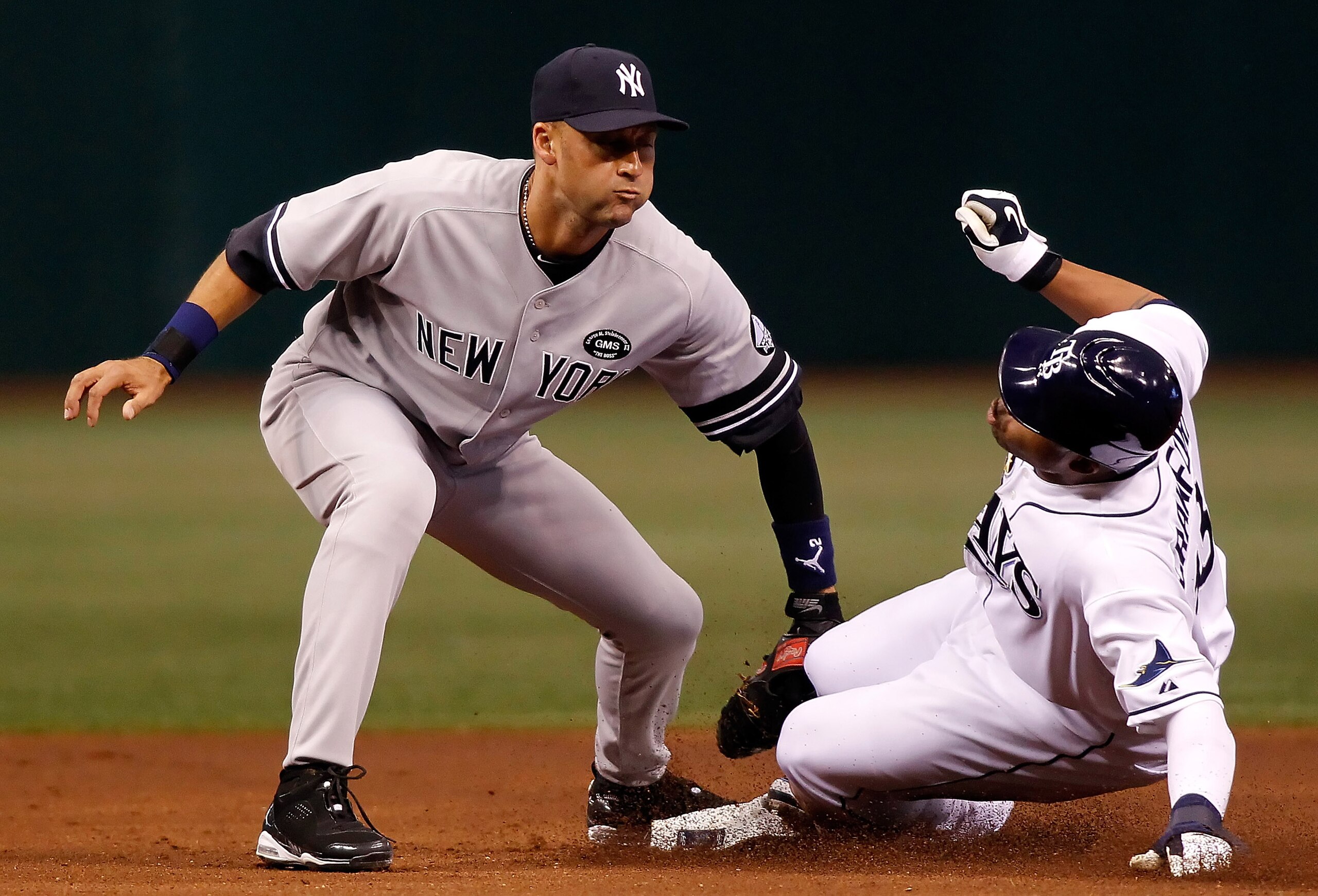 ST PETERSBURG, FL - JULY 31:  Outfielder Carl Crawford #13 of the Tampa Bay Rays steals his 400th career base as shortstop Derek Jeter #2 of the New York Yankees is late with the tag during the game at Tropicana Field on July 31, 2010 in St. Petersburg, F
