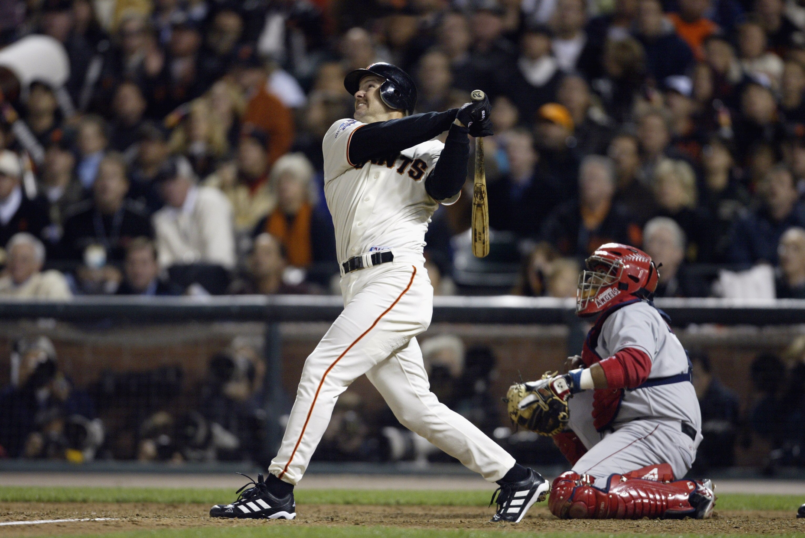 SAN FRANCISCO - OCTOBER 23:  Jeff Kent #21 of the San Francisco Giants hits a sacrifice fly to score teammate Kenny Lofton #1 in the fifth inning against the Anaheim Angels during game four of the World Series on October 23, 2002 at Pacific Bell Park in S