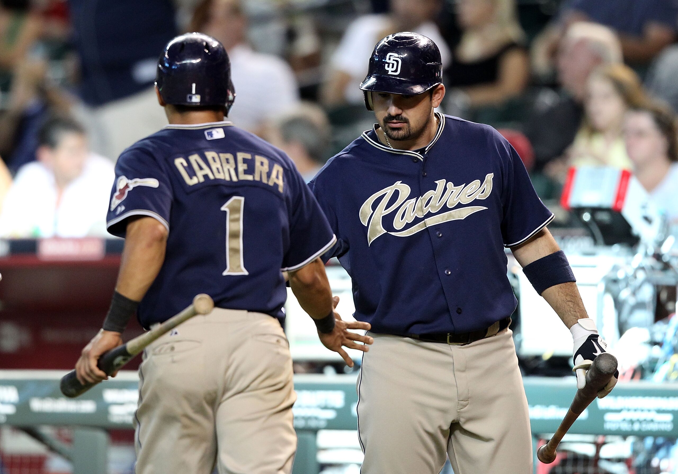 PHOENIX - SEPTEMBER 01:  Adrian Gonzalez #23 of the San Diego Padres high fives teammate Everth Cabrera #1 after he scored a run against the Arizona Diamondbacks during the Major League Baseball game at Chase Field on September 1, 2010 in Phoenix, Arizona