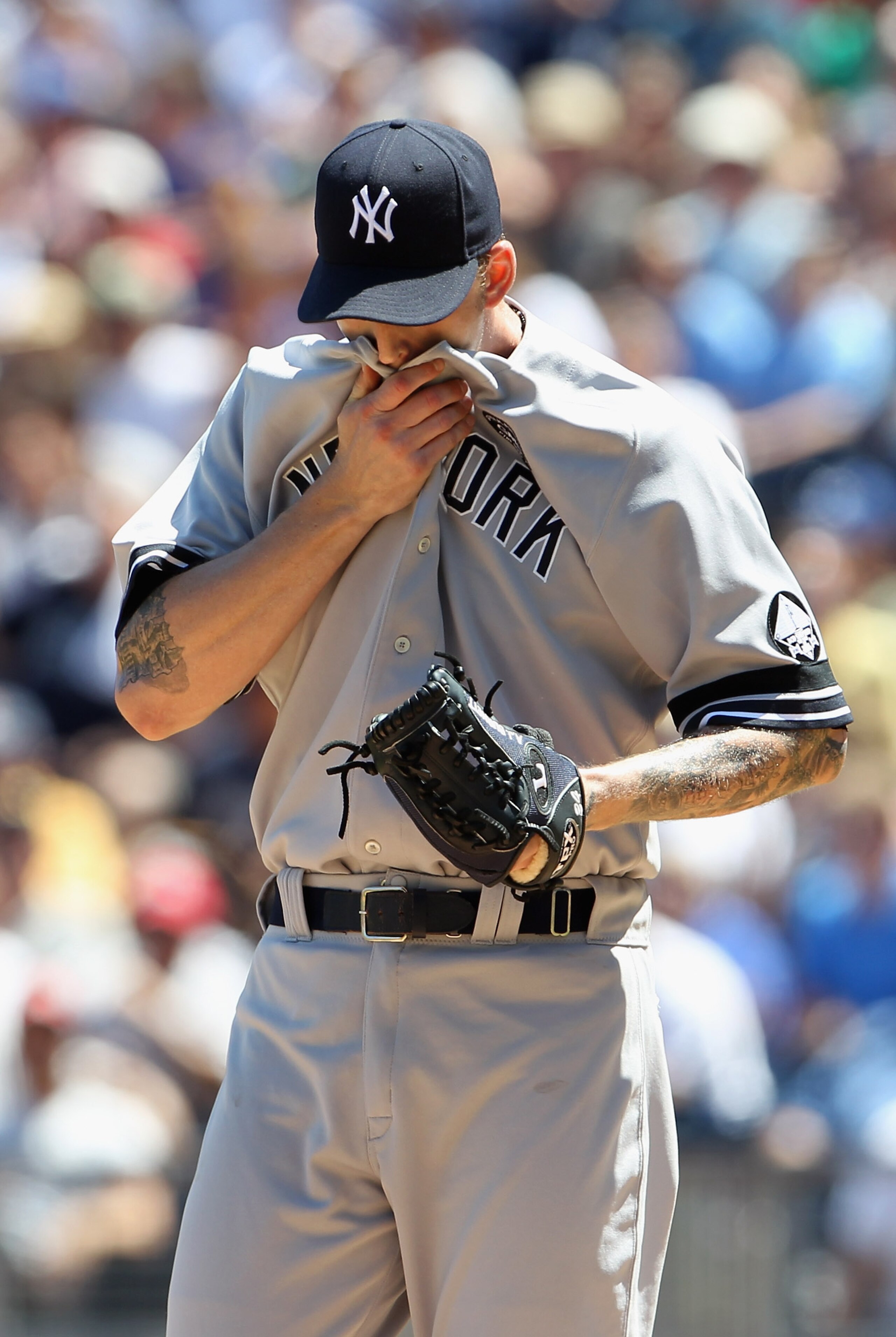 KANSAS CITY, MO - AUGUST 15:  Starting pitcher A.J. Burnett #34 of the New York Yankees wipes his face during the game against the Kansas City Royals on August 15, 2010 at Kauffman stadium in Kansas City, Missouri.  (Photo by Jamie Squire/Getty Images)
