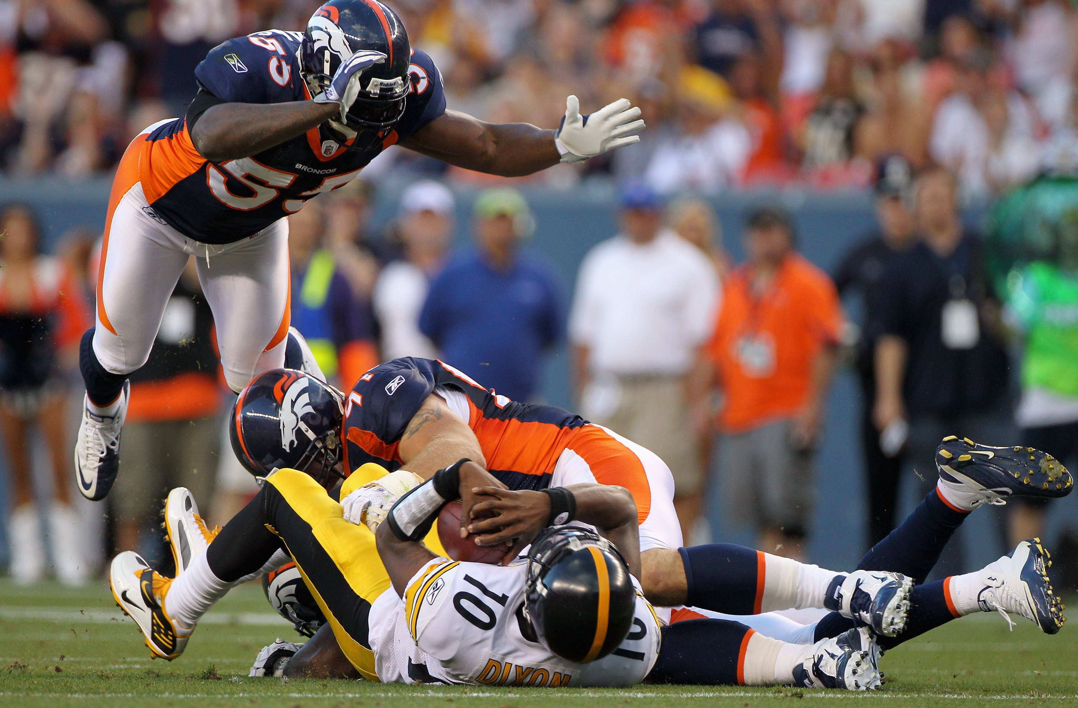 DENVER - AUGUST 29:  Quarterback Dennis Dixon #10 of the Pittsburgh Steelers is sacked by Robert Ayers #56 as Justin Bannan #97 and D.J. Williams #55 of the Denver Broncos get in on the action during preseason NFL action at INVESCO Field at Mile High on A