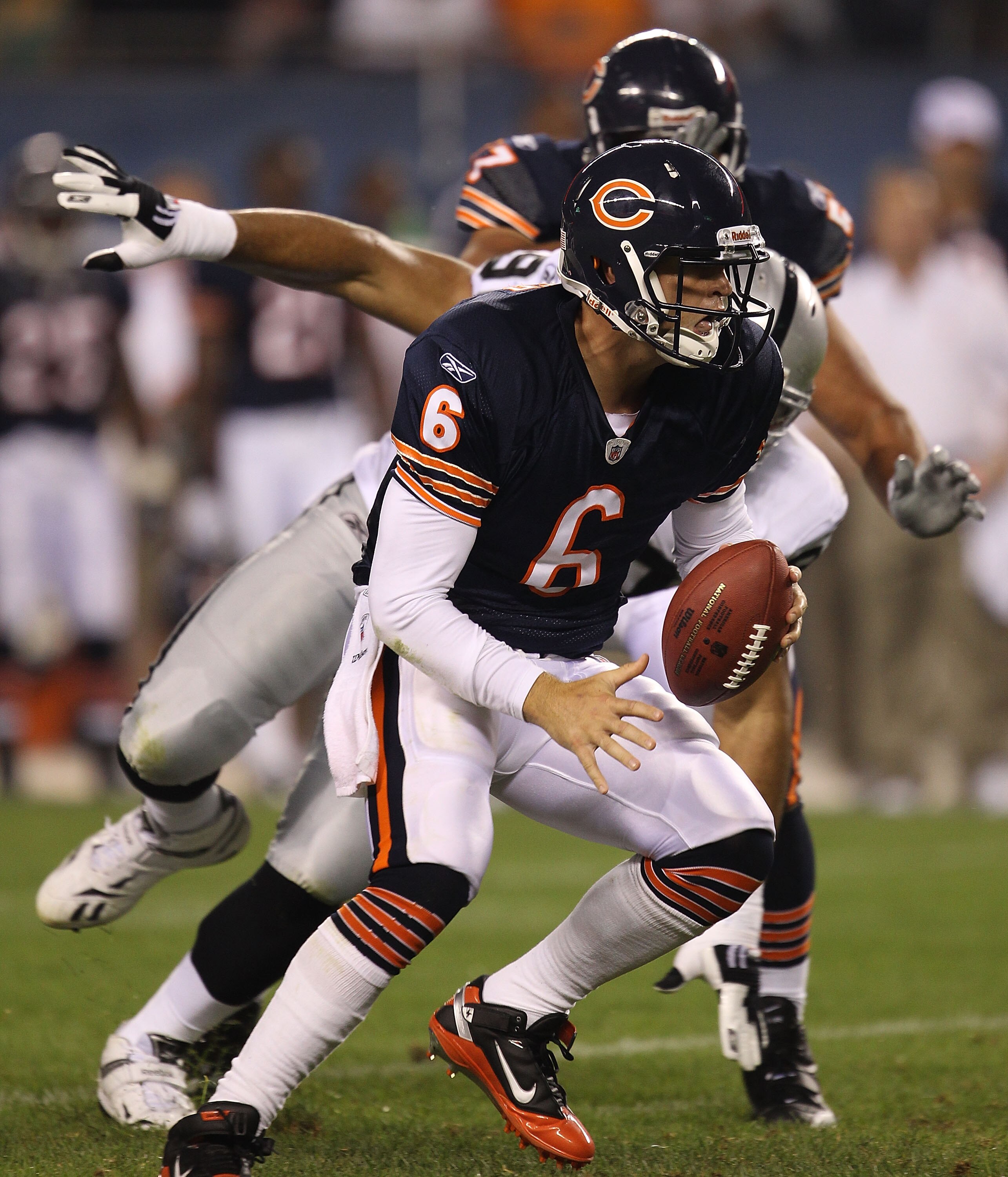CHICAGO - AUGUST 21: Jay Cutler #6 of the Chicago Bears escapes from Desmond Bryant #90 of the Oakland Raiders during a preseason game at Soldier Field on August 21, 2010 in Chicago, Illinois. (Photo by Jonathan Daniel/Getty Images)