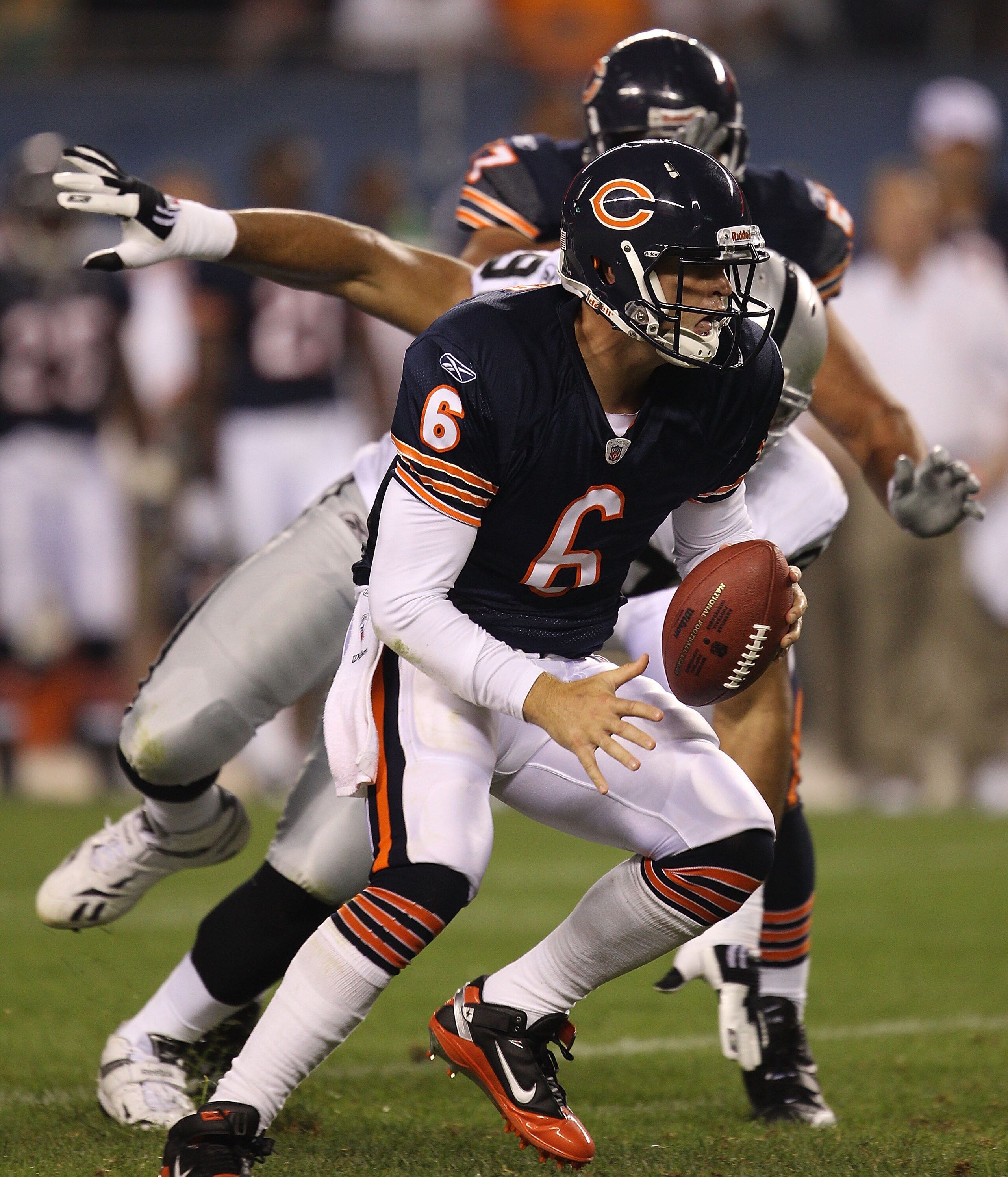 CHICAGO - AUGUST 21: Jay Cutler #6 of the Chicago Bears escapes from Desmond Bryant #90 of the Oakland Raiders during a preseason game at Soldier Field on August 21, 2010 in Chicago, Illinois. (Photo by Jonathan Daniel/Getty Images)