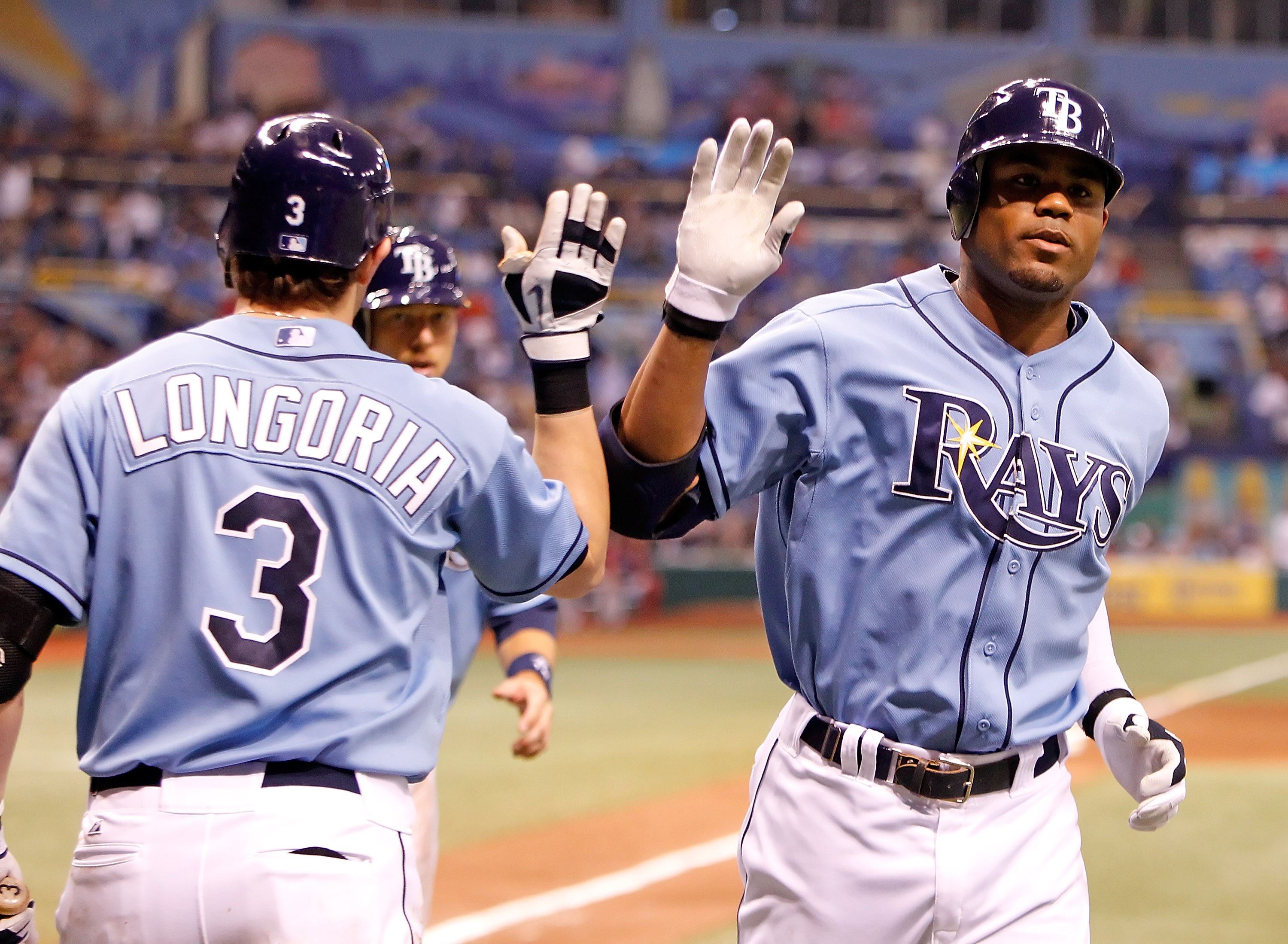 ST. PETERSBURG - AUGUST 29:  Outfielder Carl Crawford #13 (right) of the Tampa Bay Rays is congratulated by Evan Longoria #3 after his home run against the Boston Red Sox during the game at Tropicana Field on August 29, 2010 in St. Petersburg, Florida.  (