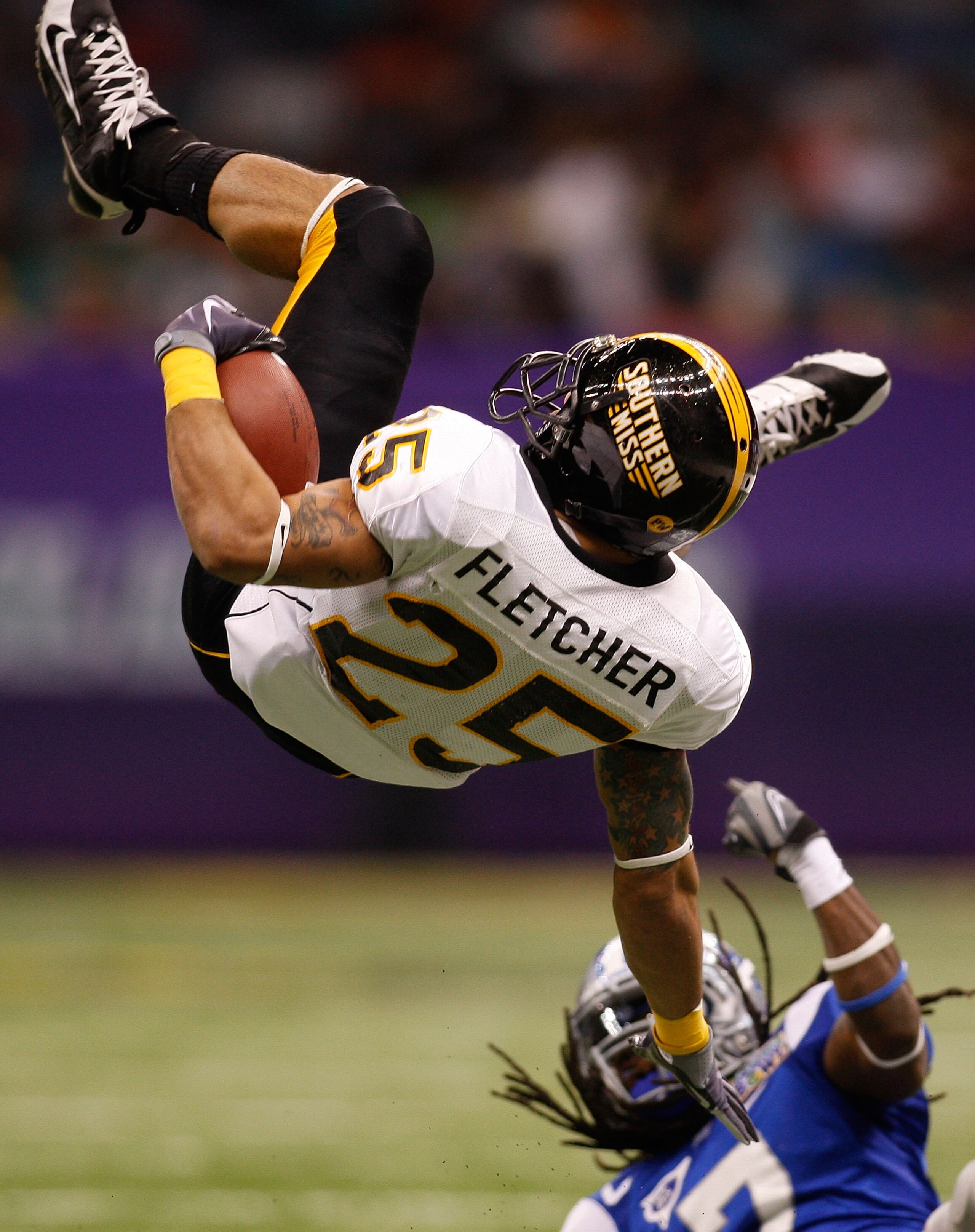 NEW ORLEANS - DECEMBER 20: Damion Fletcher #25 of the Southern Miss Golden Eagles is flipped upside down by Alex Suber #7 of the Middle Tennessee Blue Raiders during the R+L Carriers New Orleans Bowl at the Louisiana Superdome on December 20, 2009 in New NEW ORLEANS - DECEMBER 20: Damion Fletcher #25 of the Southern Miss Golden Eagles is flipped upside down by Alex Suber #7 of the Middle Tennessee Blue Raiders during the R+L Carriers New Orleans Bowl at the Louisiana Superdome on December 20, 2009 in New