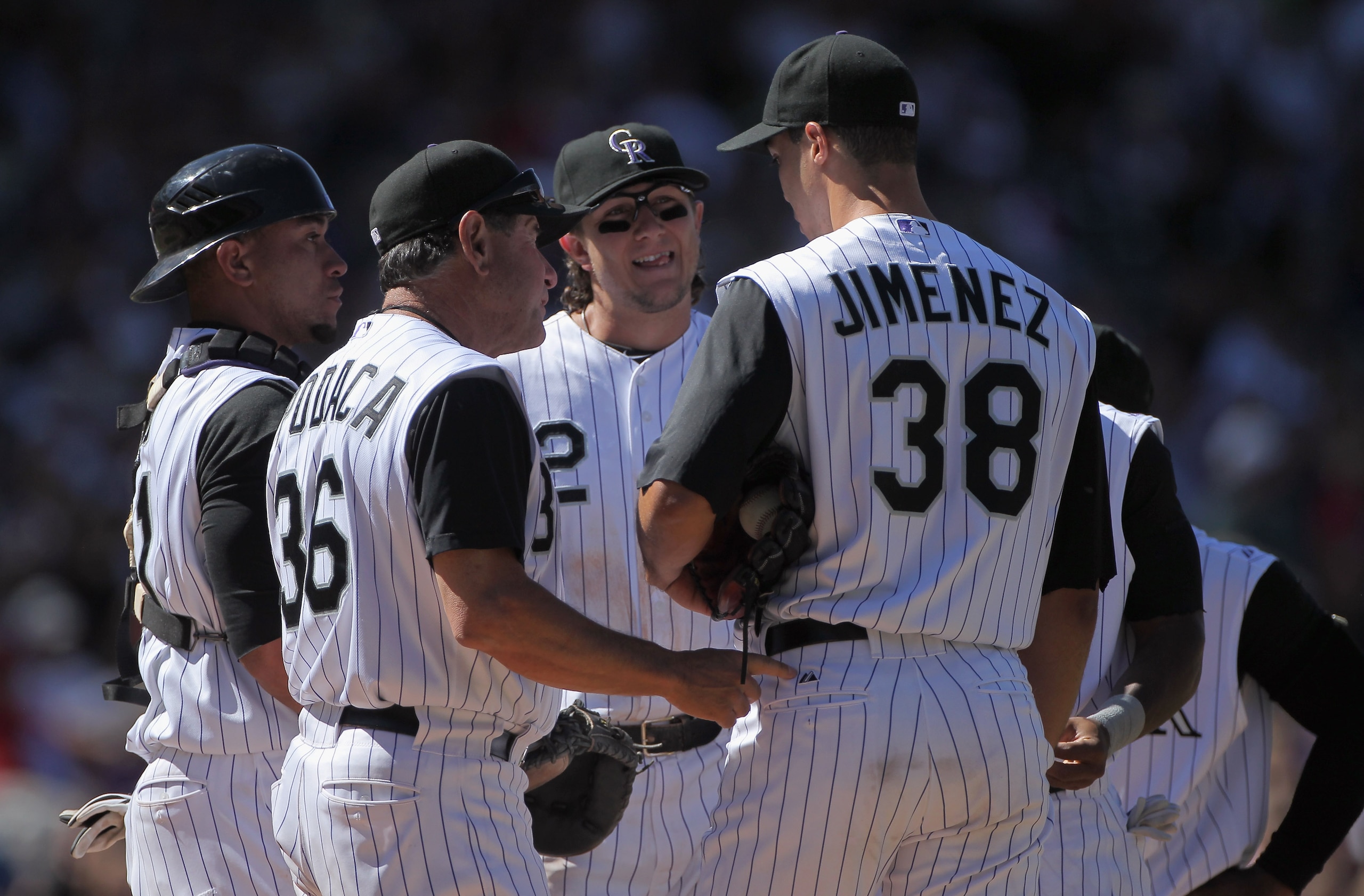 DENVER - SEPTEMBER 06:  Starting pitcher Ubaldo Jimenez #38 of the Colorado Rockies is visited on the mound by pitching coach Bob Apodaca #36 as well as catcher Miguel Olivo #21 and shortstop Troy Tulowitzki #2 as he faces the Cincinnati Reds in the sixth