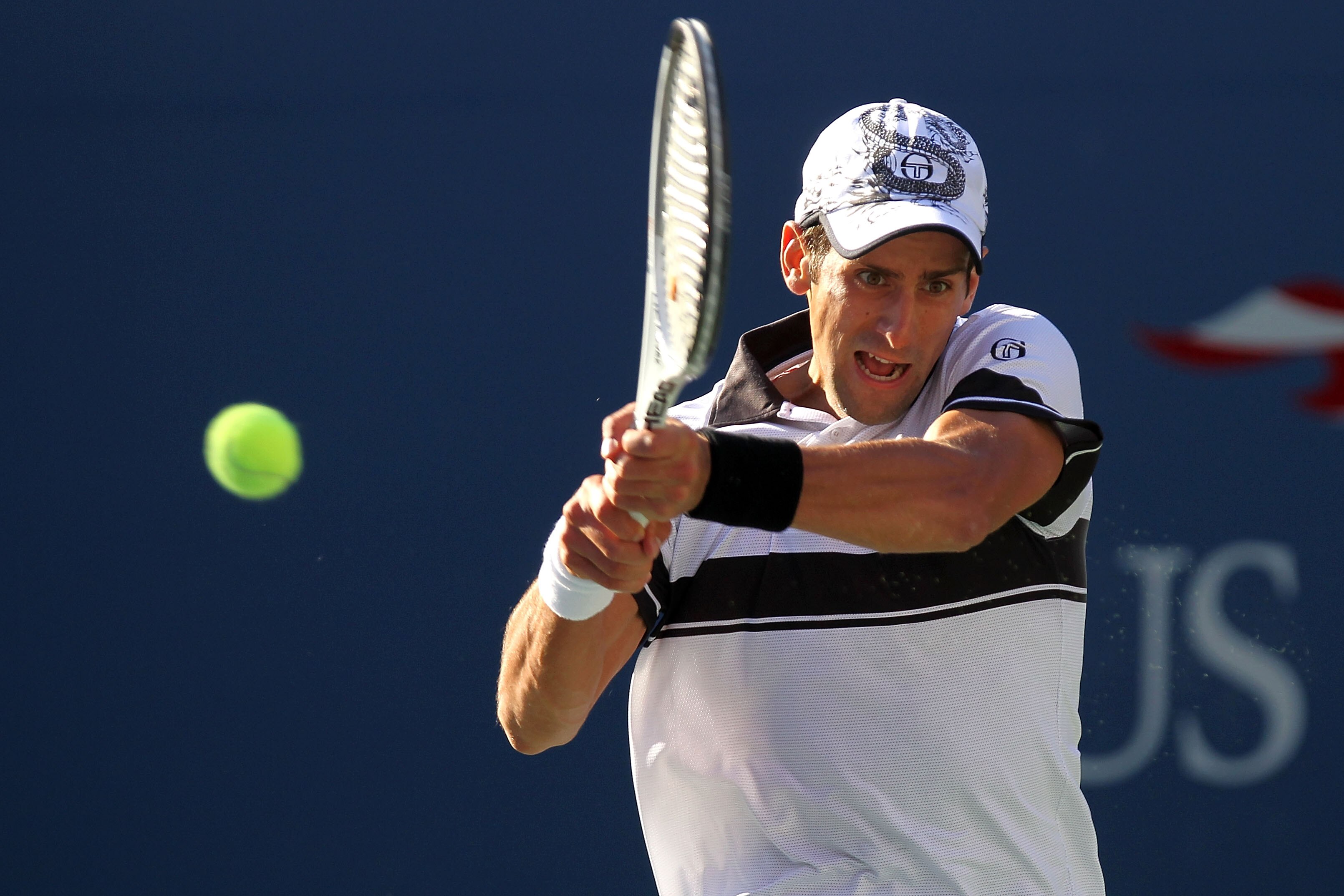 NEW YORK - SEPTEMBER 08:  Novak Djokovic of Serbia hits a return against Gael Monfils of France during his men's singles quarterfinal match on day ten of the 2010 U.S. Open at the USTA Billie Jean King National Tennis Center on September 8, 2010 in the Fl
