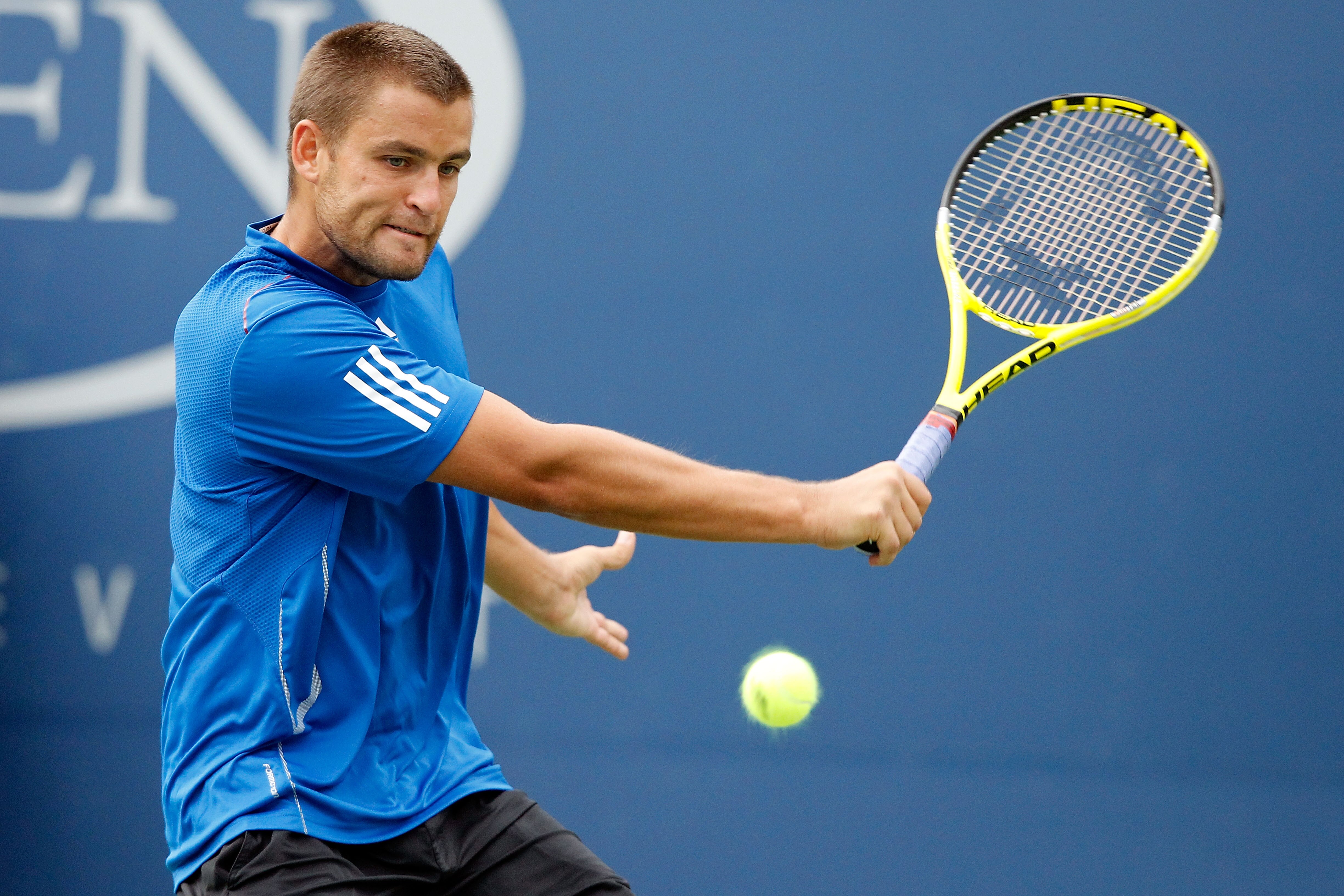 NEW YORK - SEPTEMBER 09:  Mikhail Youzhny of Russia returns a shot against Stanislas Wawrinka of Switzerland during his men's single quarterfinal match on day eleven of the 2010 U.S. Open at the USTA Billie Jean King National Tennis Center on September 9,