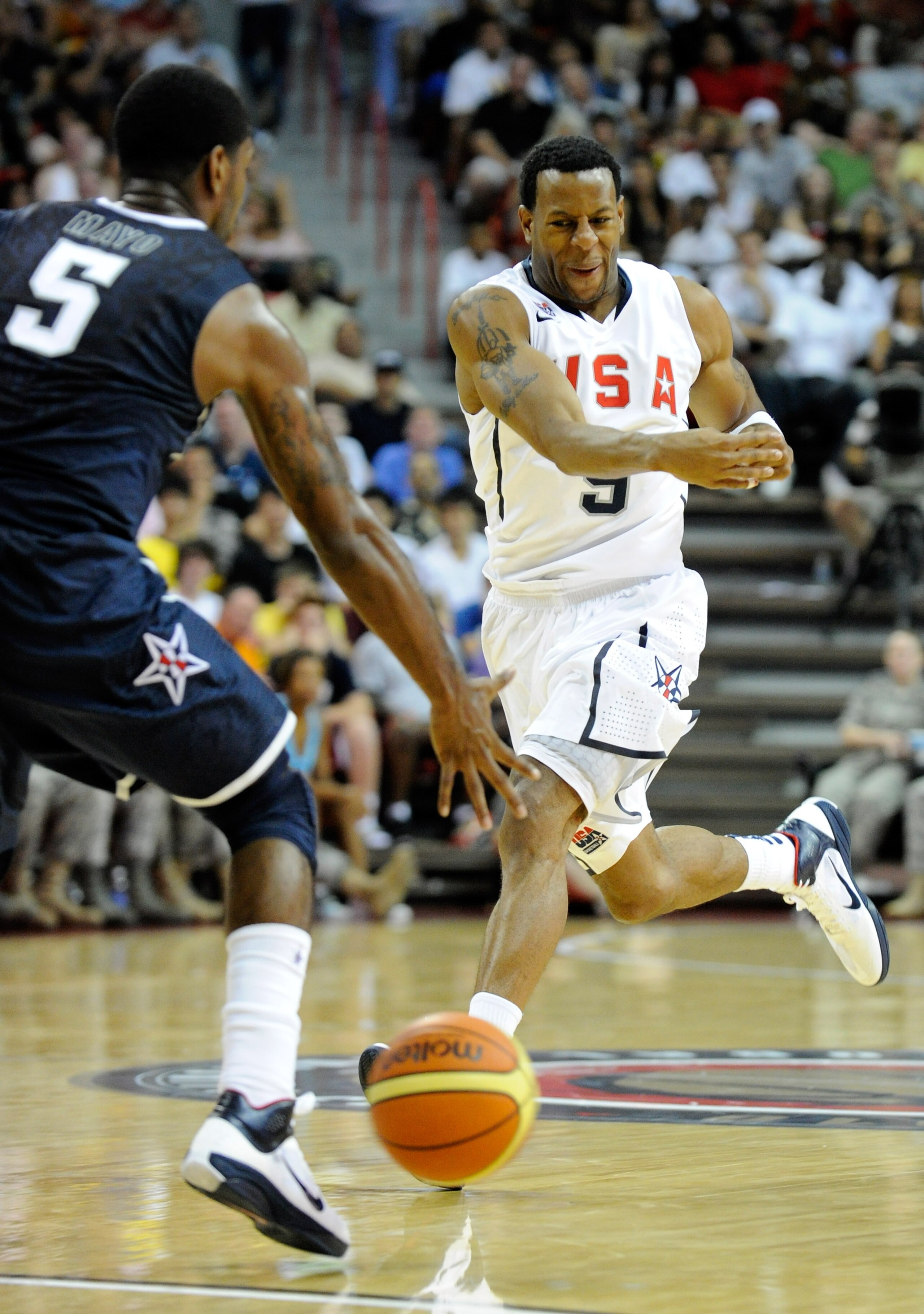 LAS VEGAS - JULY 24: Andre Iguodala #9 of the 2010 USA Basketball Men's National Team passes the ball past O.J. Mayo #5 of the 2010 USA Basketball Men's National Team during a USA Basketball showcase at the Thomas & Mack Center July 24, 2010 in Las Vega LAS VEGAS - JULY 24: Andre Iguodala #9 of the 2010 USA Basketball Men's National Team passes the ball past O.J. Mayo #5 of the 2010 USA Basketball Men's National Team during a USA Basketball showcase at the Thomas & Mack Center July 24, 2010 in Las Vega