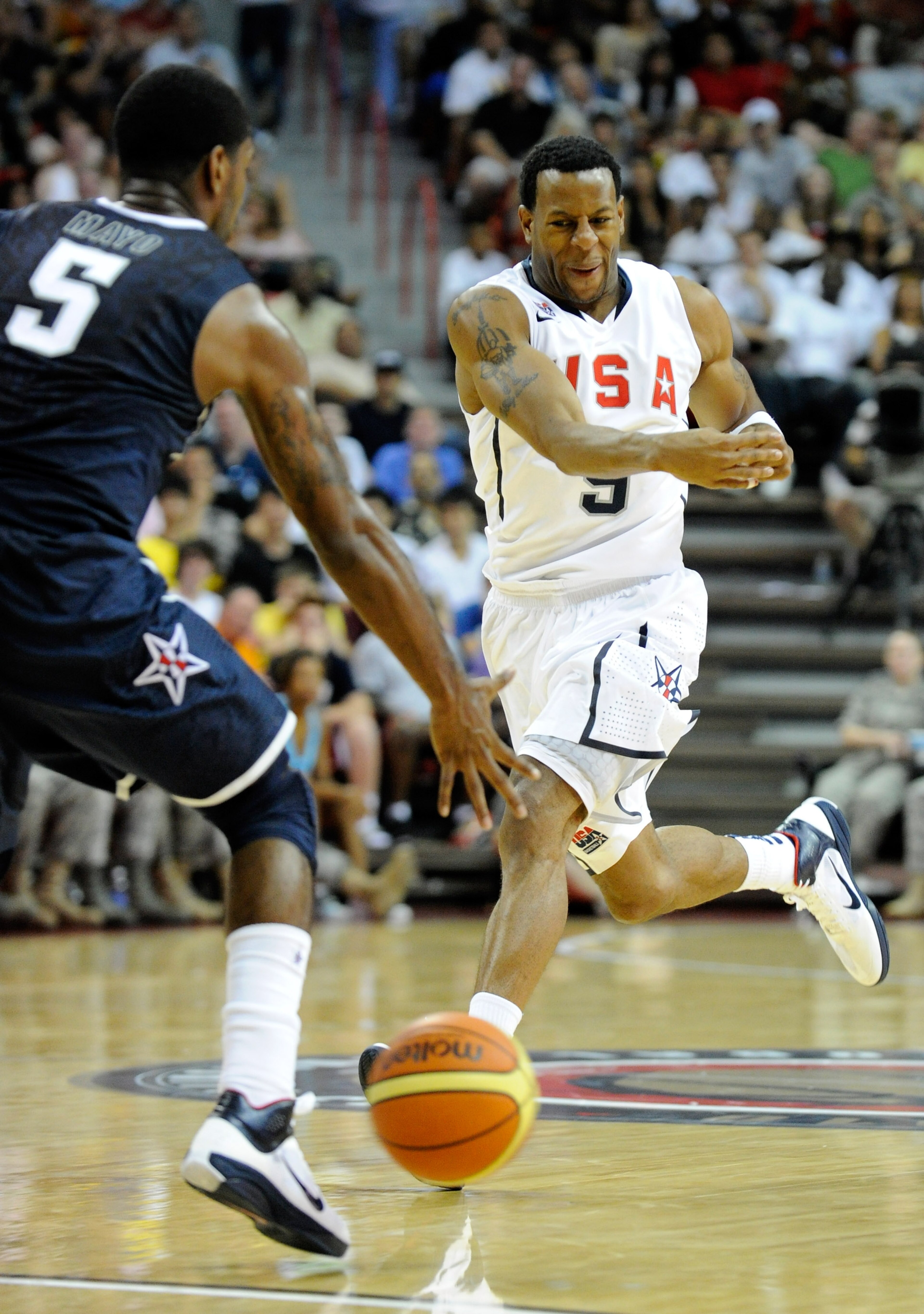 LAS VEGAS - JULY 24:  Andre Iguodala #9 of the 2010 USA Basketball Men's National Team passes the ball past  O.J. Mayo #5 of the 2010 USA Basketball Men's National Team during a USA Basketball showcase at the Thomas & Mack Center July 24, 2010 in Las Vega