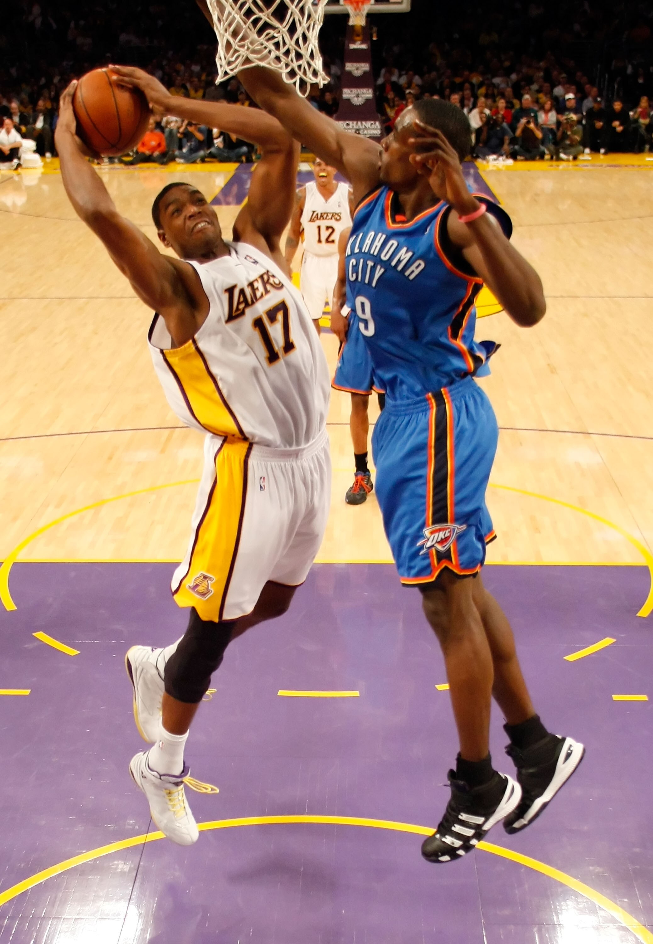 LOS ANGELES, CA - NOVEMBER 22:  Andrew Bynum #17 of the Los Angeles Lakers drives to the basket past Serge Ibaka #9 of the Oklahoma City Thunder in the first half at Staples Center on November 22, 2009 in Los Angeles, California. The Lakers defeated the T