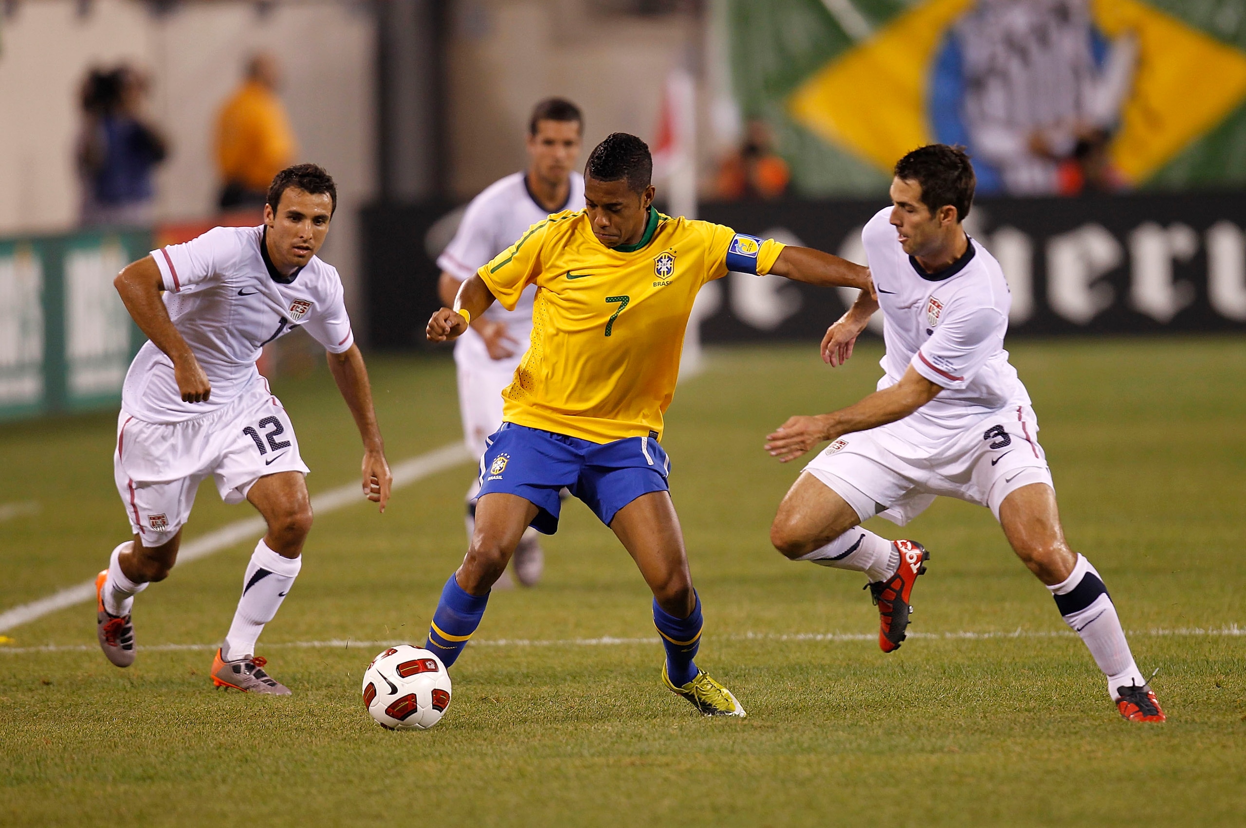 EAST RUTHERFORD, NJ - AUGUST 10: Jonathan Bornstein #12 and Carlos Bocanegra #3 of the U.S. guard Robinho #7 of Brazil in the first half of a friendly match at the New Meadowlands on August 10, 2010 in East Rutherford, New Jersey. (Photo by Jeff Zelevansk